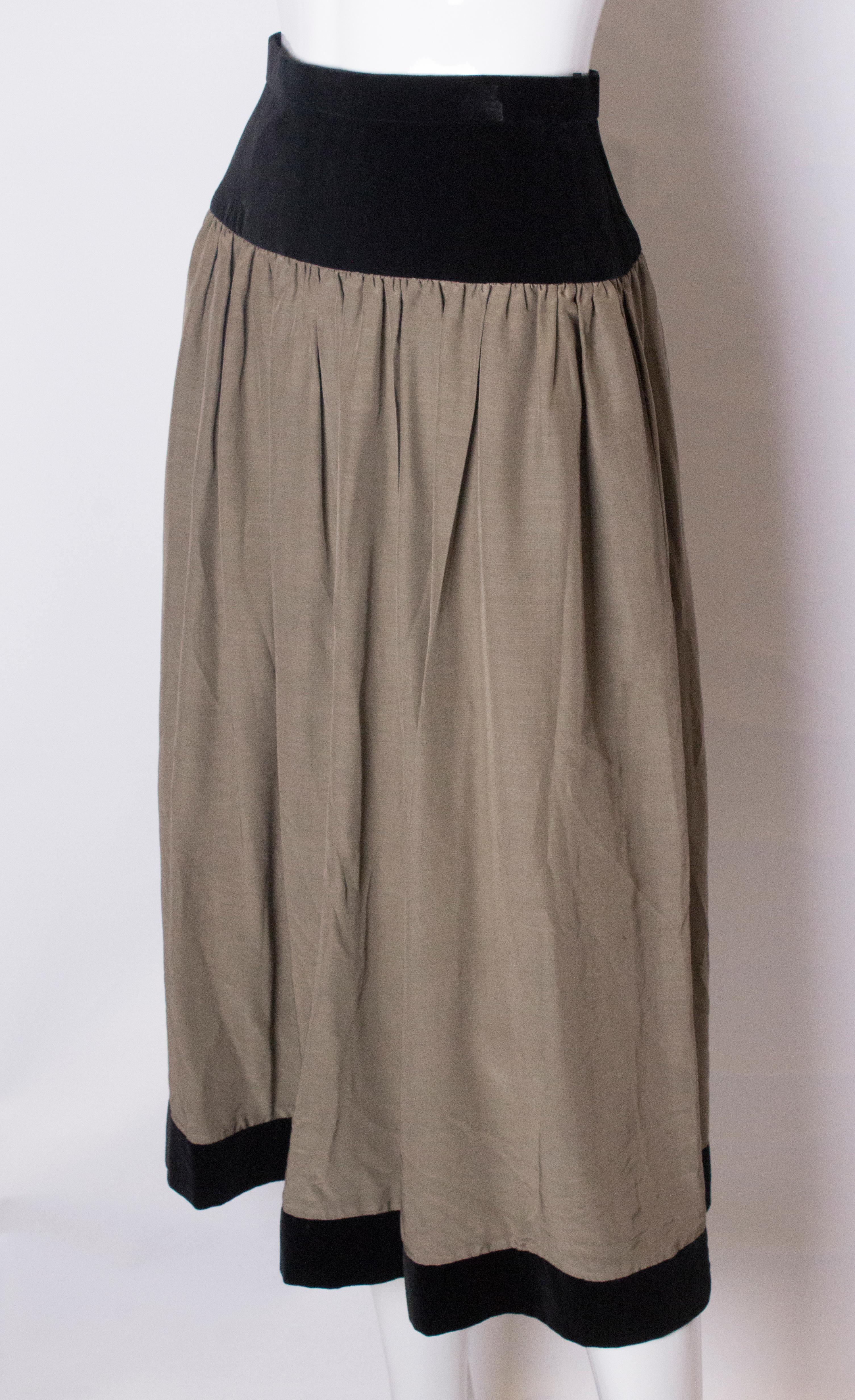 
A vintage Roland Klein skirt in  black silk velvet and  greysilk The skirt has a velvet band from the waist down producing a flattering line, and grey silk for the main part of the skirt with a 2 1/4'' black velvet border at the hem.  The skirt is