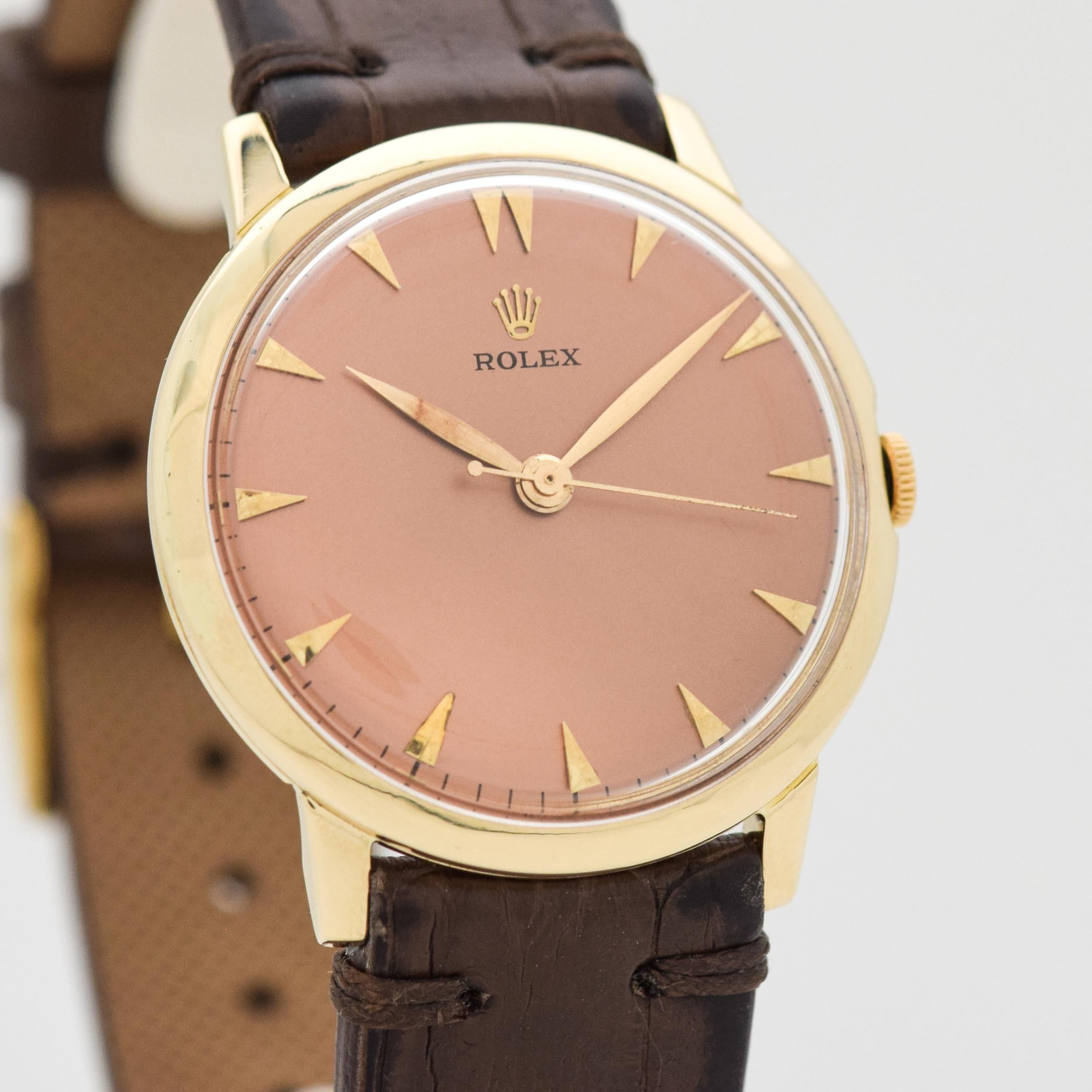 1960's Vintage Rolex 14k Yellow Gold Rolex Recognition Watch Issued from L'Oreal Cosmetics with Salmon Color Dial with Applied Gold Color Elongated Beveled Triangle Markers. Case size, 33mm x 38mm lug to lug (1.3 in. x 1.5 in.) - Powered by a