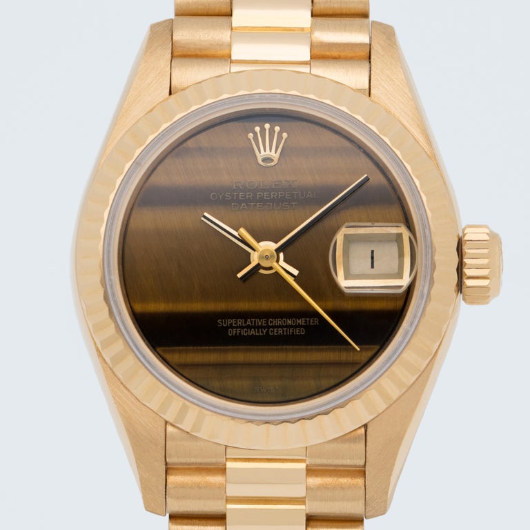 Vintage Rolex 18 Karat Yellow Gold Ladies DateJust with a RARE and original Rolex Tiger Eye dial 
circa 1991
26mm Dial
Automatic movement
Model Ref 69178

Currently fits up to a 6.5