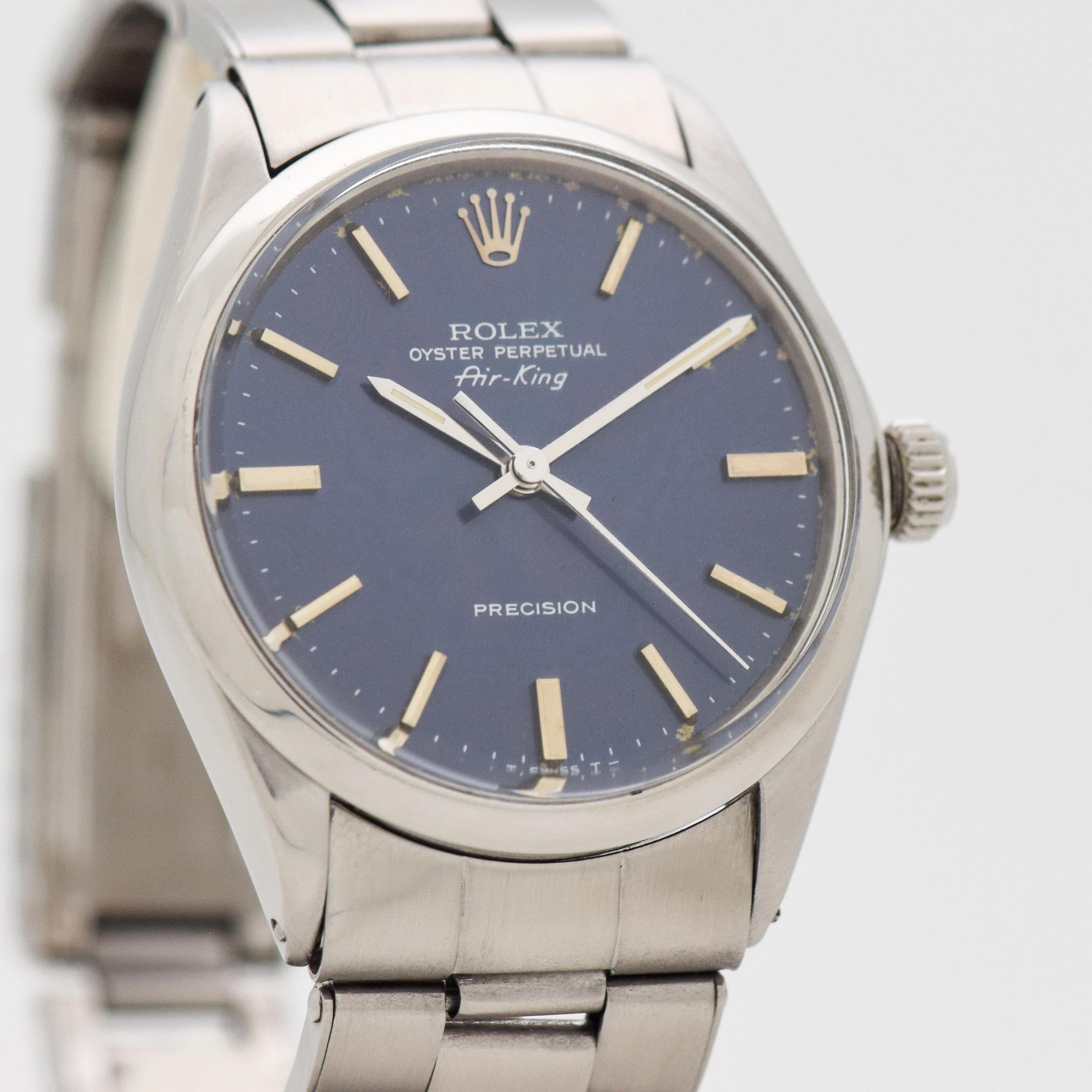 1967 Vintage Rolex Air-King Reference 5500. Stainless Steel case, that measures in at 34mm wide. Original, patinated blue dial with applied, steel bar markers. Powered by a 26-jewel, automatic caliber movement. Equipped with an original, Rolex
