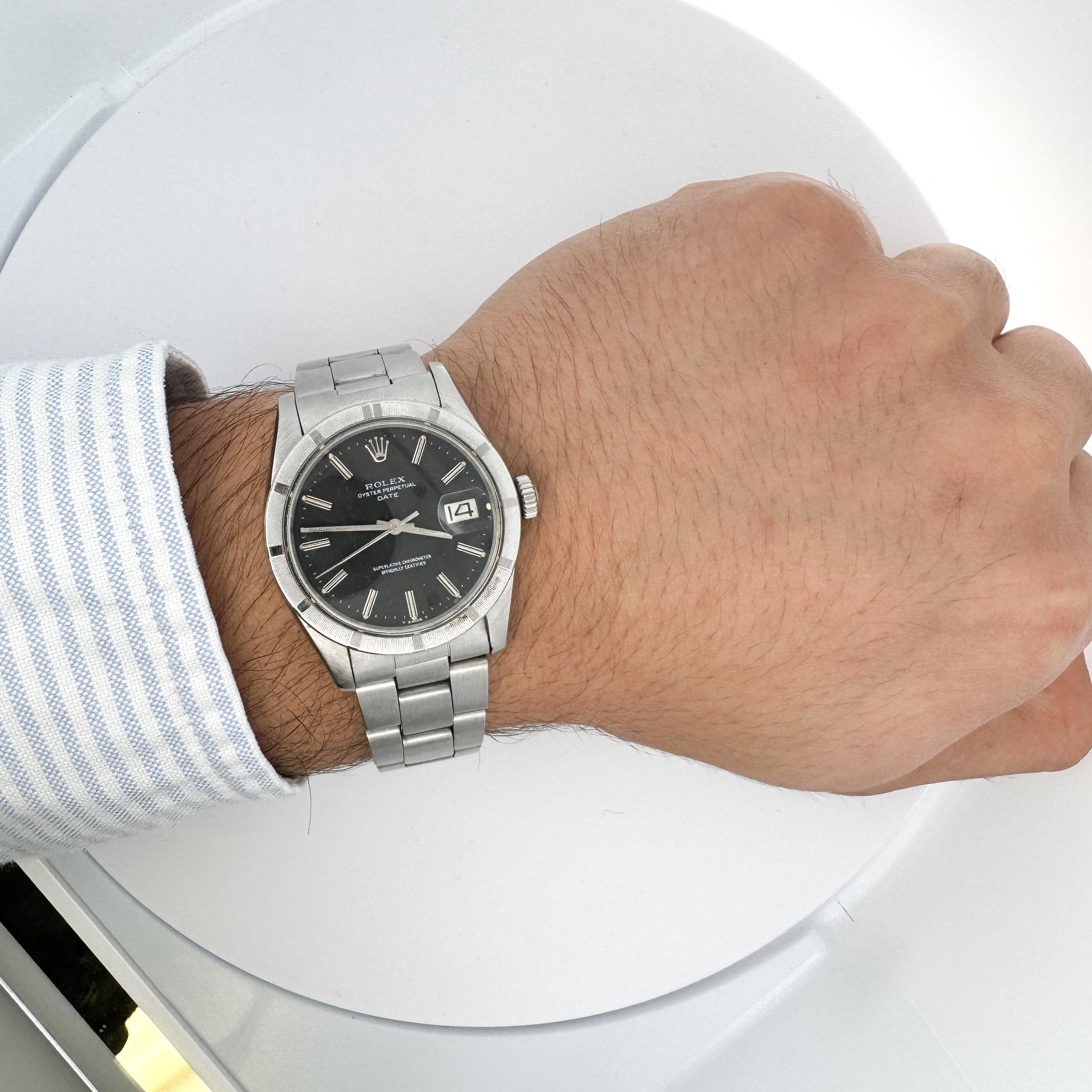 A vintage Rolex Oyster Perpetual Date, Ref. 15210, from 1975-featuring a 34mm stainless steel case, black dial, and an engine-turned bezel. The perfect entry level Rolex unisex watch.

Details:
Brand: Rolex
Model: Oyster Perpetual Date
Reference