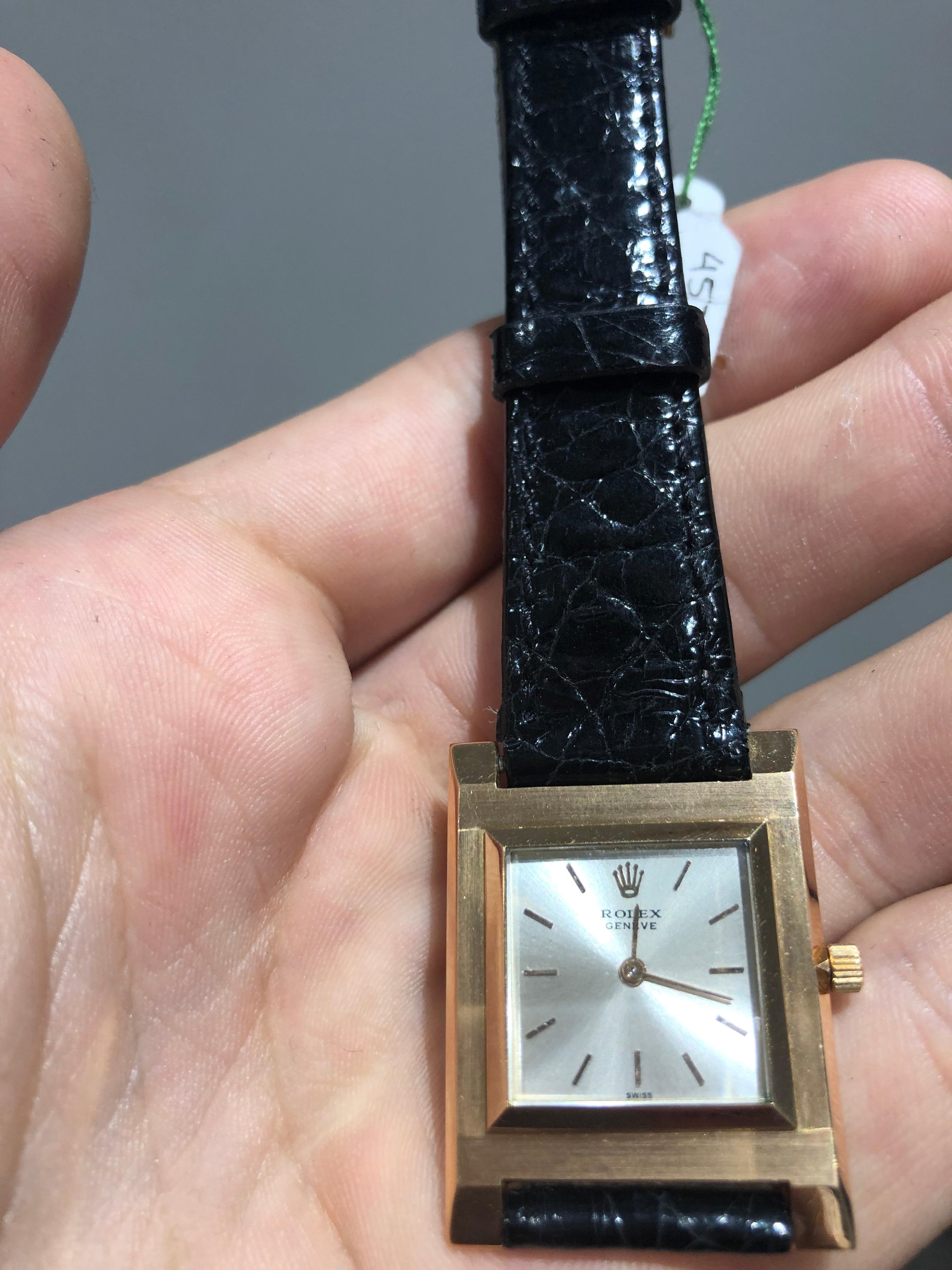 An 18k Rose Gold Vintage Cellini Gents Wristwatch from the year 1959, silver dial with applied index batons, an 18k rose gold stepped bezel, an original brand new black leather strap with an 18k yellow gold pin buckle, sapphire glass, manual wind