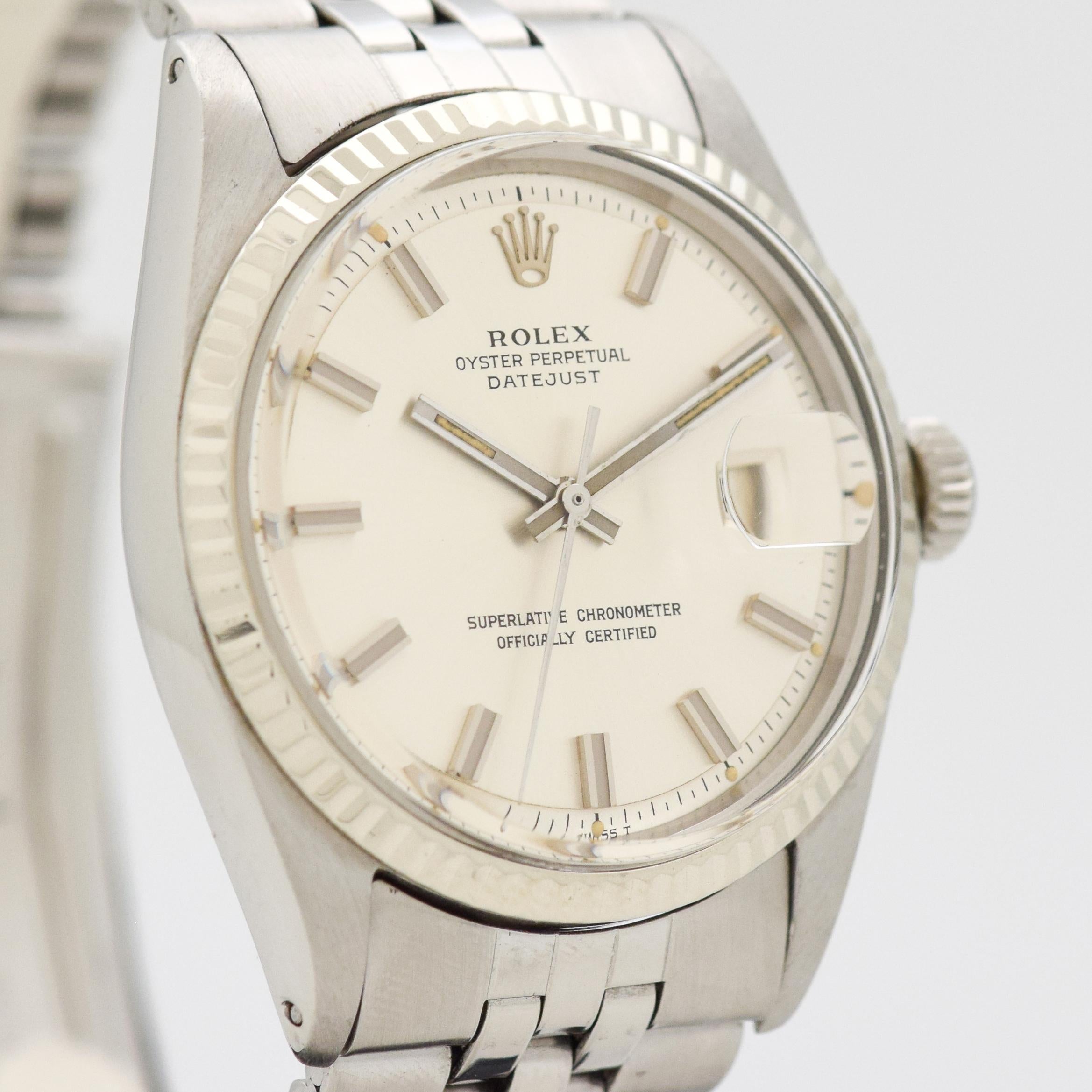 1970 Vintage Rolex Datejust Ref. 1601 14k White Gold Fluted Replacement Bezel and Stainless Steel Watch with Original Desirable and Relatively Rare Wide Boy Silver Dial with Wide Stick/Bar/Baton Markers with Original Rolex Stainless Steel Jubilee