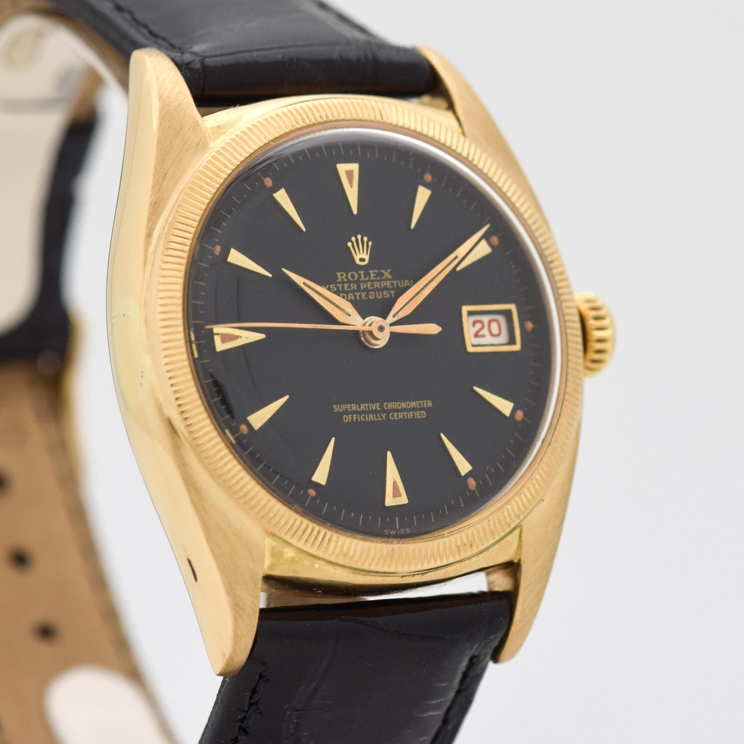 1952 Vintage Rolex Datejust Ovettone Reference 6105. 18K Yellow Gold case with a fluted bezel. Black dial with applied, yellow gold-colored, arrow markers. All Red Date Wheel. Equipped with an 20-jewel, automatic caliber movement.  Case Exterior
