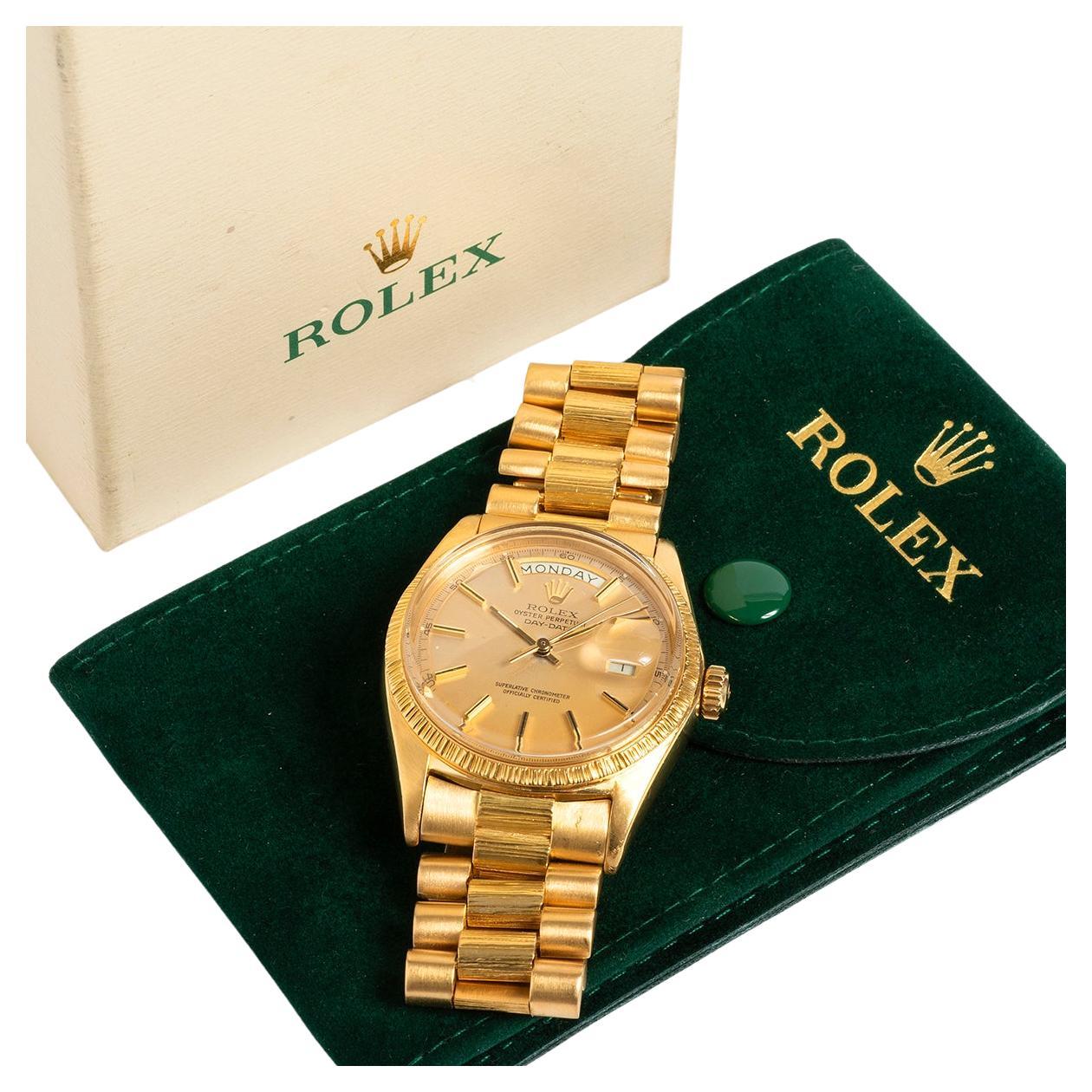 Our vintage Rolex Day-Date 1807, is the rarer bark finished reference of a day date: and is a highly original example, featuring an 18k yellow gold case with bark bezel and president bracelet with bark centre links and adjustable folding clasp. Also