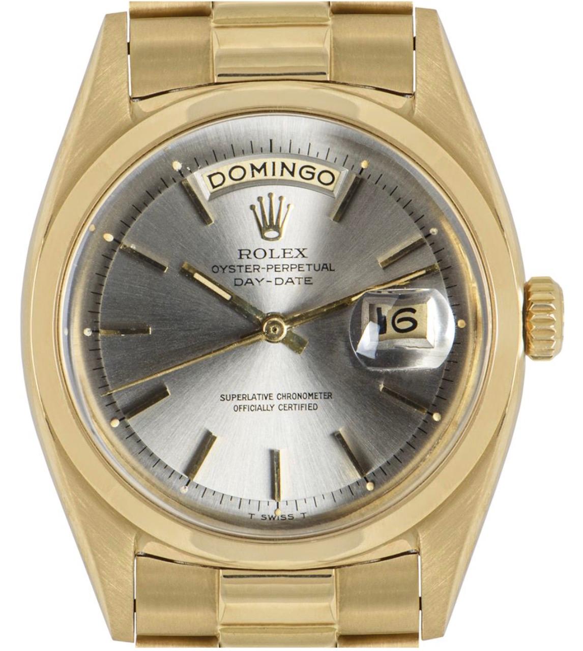 An 18k yellow gold Oyster Perpetual Day-Date vintage wristwatch. Features a silver dial with applied hour markers, a date aperture, and a day display. Complementing the dial is a fixed 18k yellow gold smooth bezel. 

Equipped with an 18k yellow gold