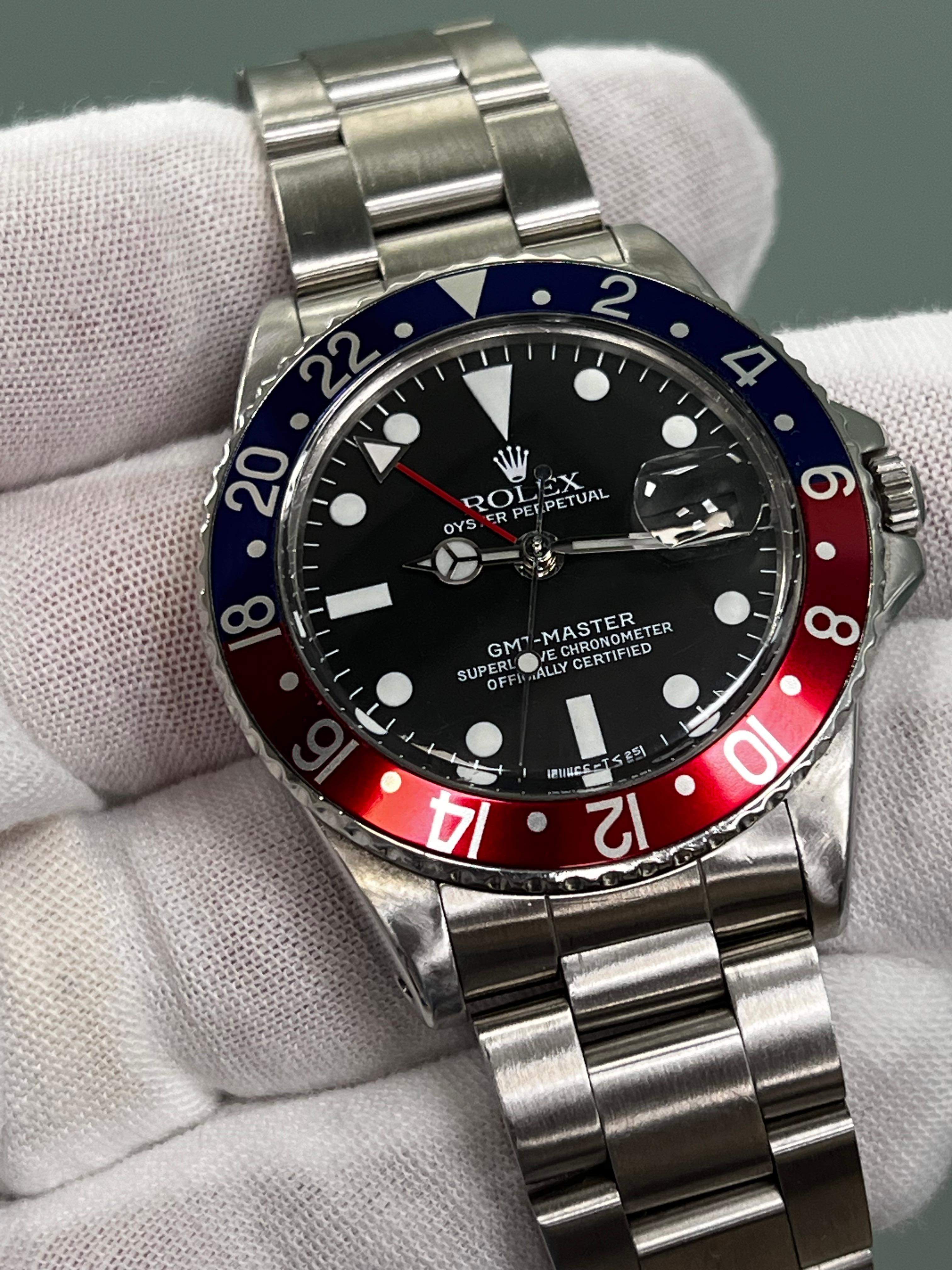 Style Number: 1675
Serial: 1274***
Year: 1966
Model: GMT Master
Case Material: Stainless Steel
Band: Stainless Steel
Bezel:  Pepsi- Red & Blue 
Dial: Black 
Face: Acrylic
Case Size: 40mm 

 Includes: 
-Rolex Watch Box
-Certified Appraisal 
-1 Year