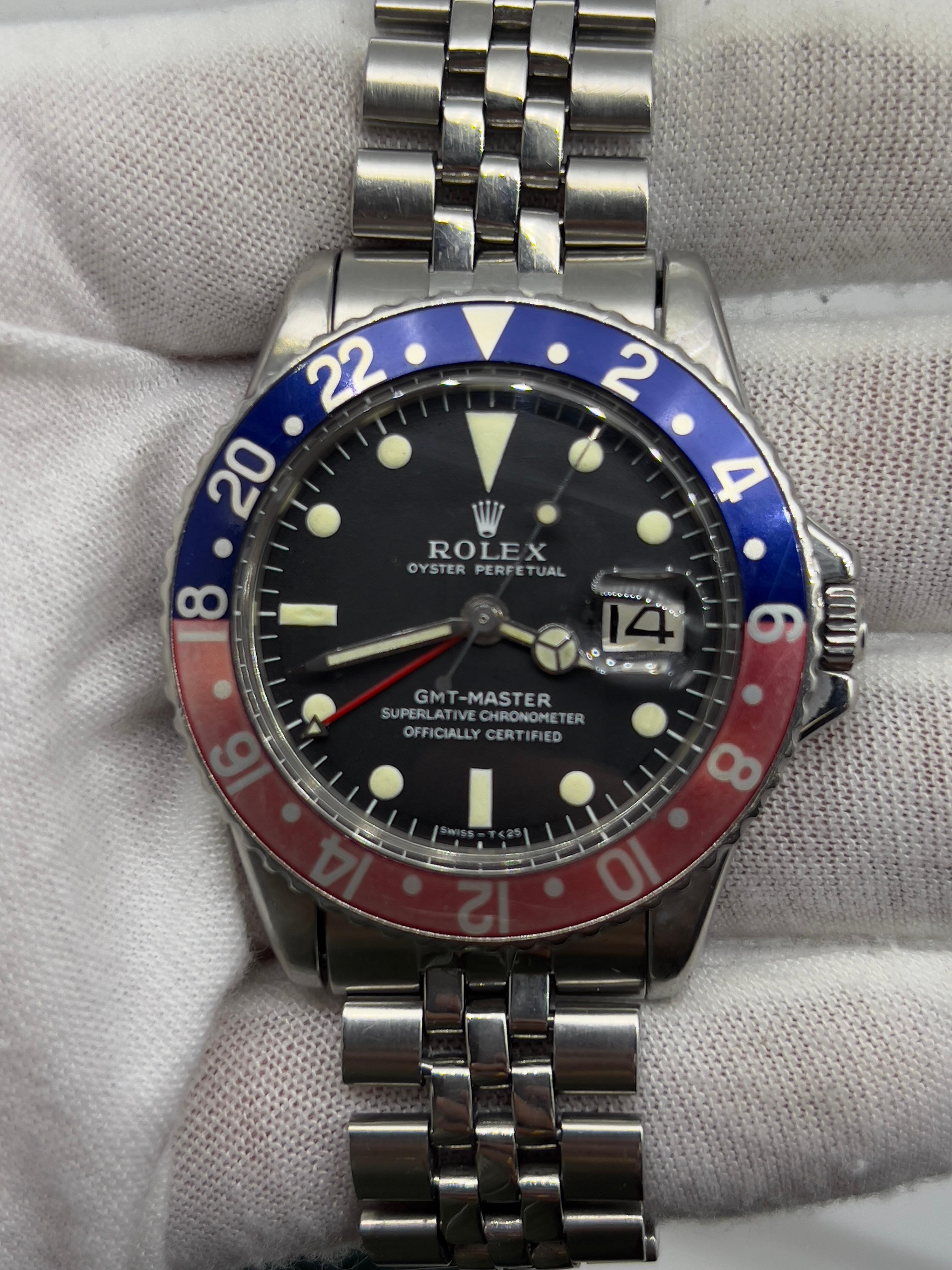 Style Number: 1675
Serial: 1644***
Year: 1967
Model: Rolex GMT Master 
Case Material: Stainless Steel
Band: Stainless Steel Jubilee Band 
Bezel:  Pepsi - Red and Blue 
Dial: Black 
Face: Acrylic 
Case Size: 40mm 
Includes: 
-Rolex Box & Service