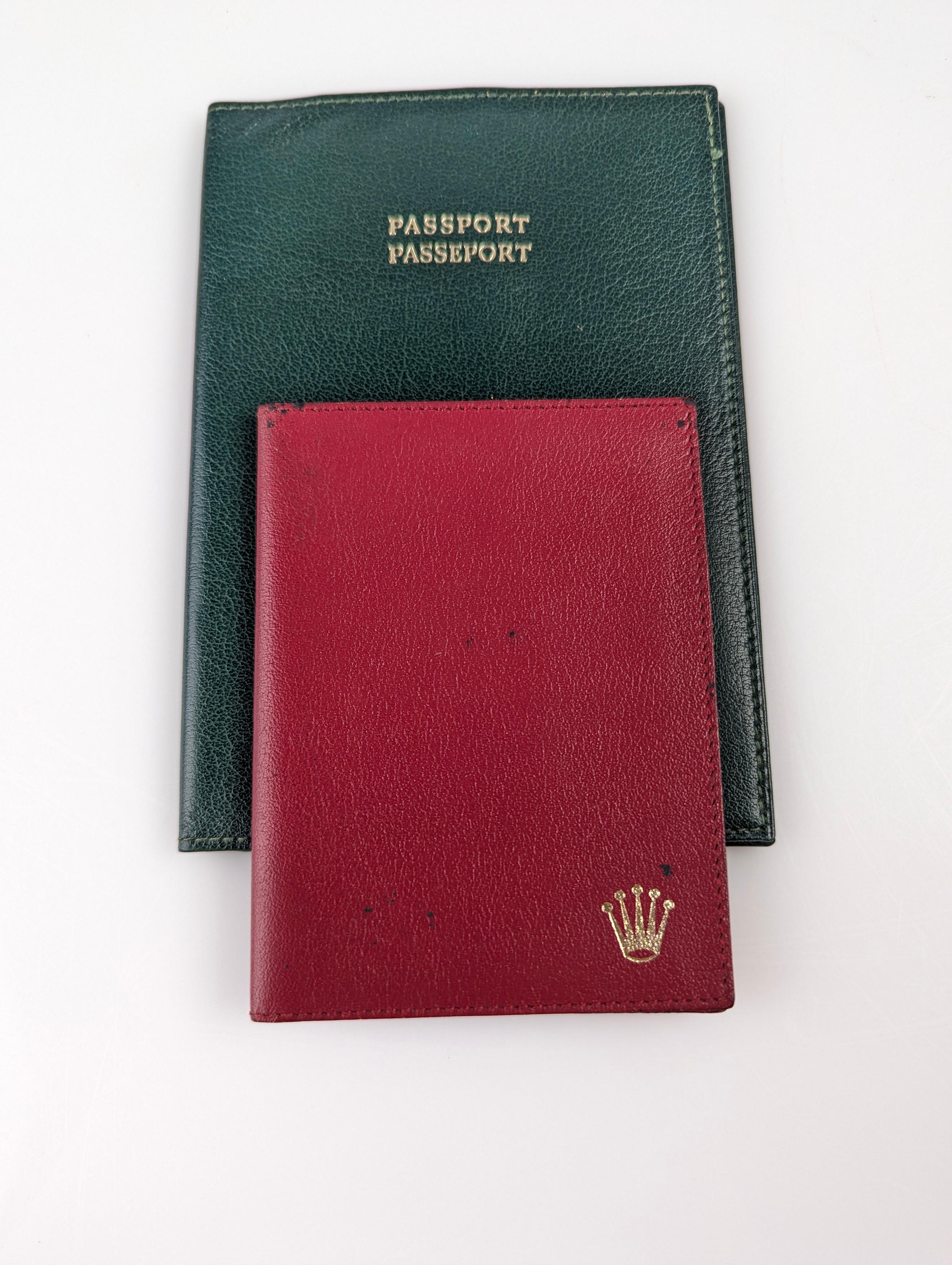 Red wallet and green passport wallet in leather by Rolex.