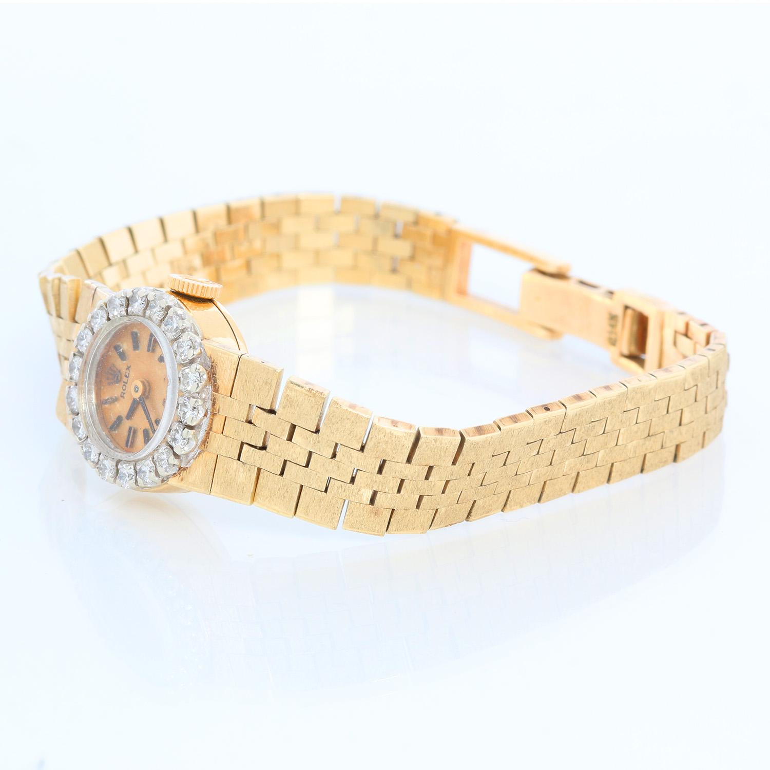 Vintage Rolex Ladies 14K  Yellow Gold Watch  - Manual winding. 14K Yellow gold dial with diamond bezel ( 15 mm). Champagne texture dial with stick hour markers. 14K Yellow gold bracelet; will fit up to a 6 1/4 inch wrist. Pre-owned with custom box.