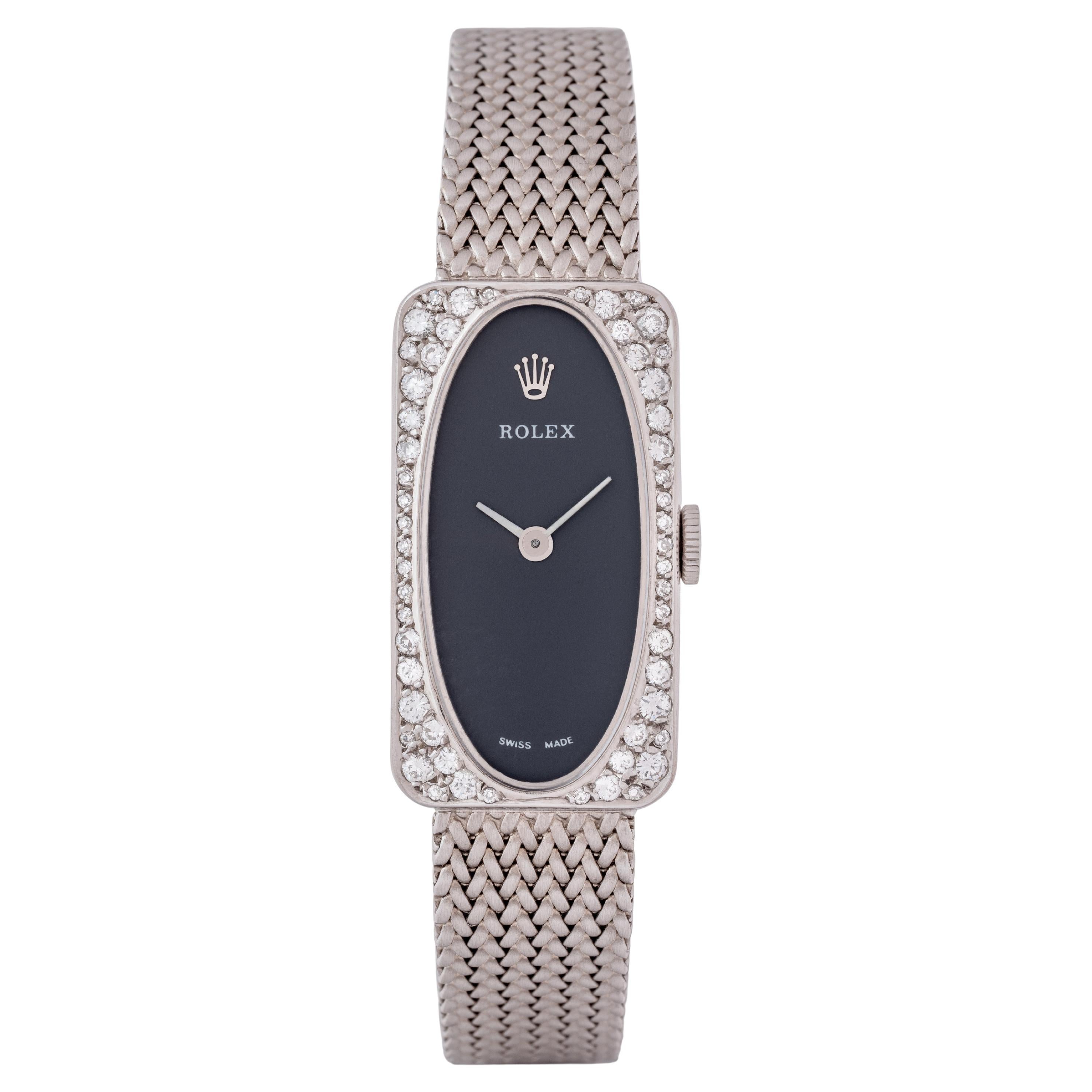 Vintage Rolex Model N371 18k White Gold 15mm x 28mm Grey Dial and Pave Diamond Halo, White Gold Integrated Bracelet, Manual Wind, Made in Switzerland c.1980

Maker:  Rolex
Model: N371
Year: 1980
Material: 18K White Gold and Diamonds
Dial: Dark Grey
