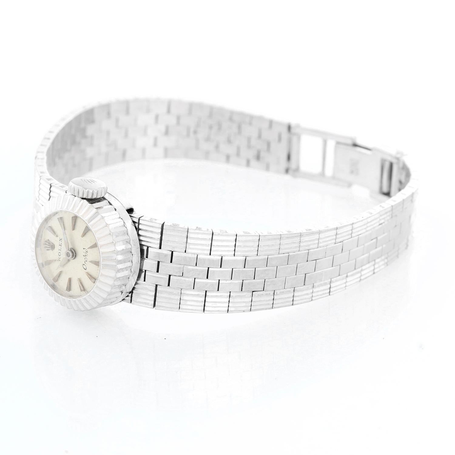 Vintage Rolex Orchid Chameleon 14K White Gold Ladies - Manual winding. 14K white gold case with slot through which bands can be interchanged (16 mm). Silver textured dial with gold stick markers. White gold bracelet measuring 6.5 inches. Pre-owned