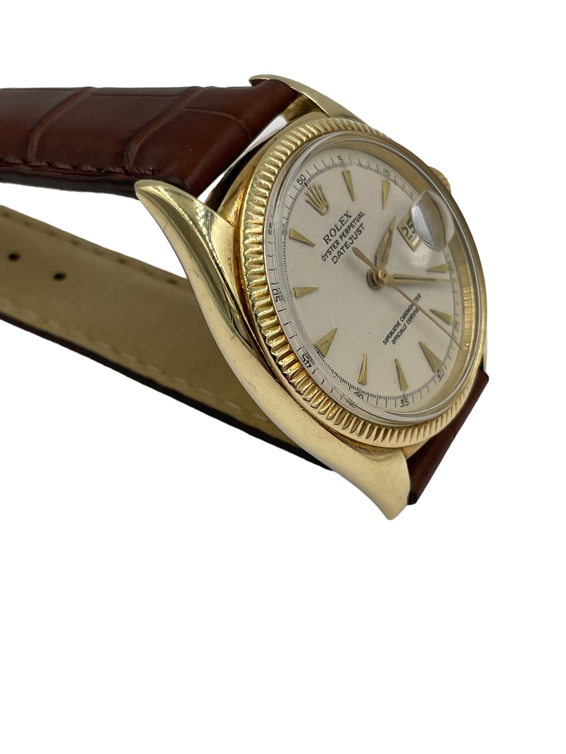 Vintage Rolex Oyster Perpetual Date Yellow Gold Wristwatch, from the 1950s

SPECIFICATIONS:

ROLEX:  model # 6305, 

METAL:  14k yellow gold case

BRACELET:  brown alligator leather band

DIMENSIONS: 36mm

CONDITION:  high magnification photographs
