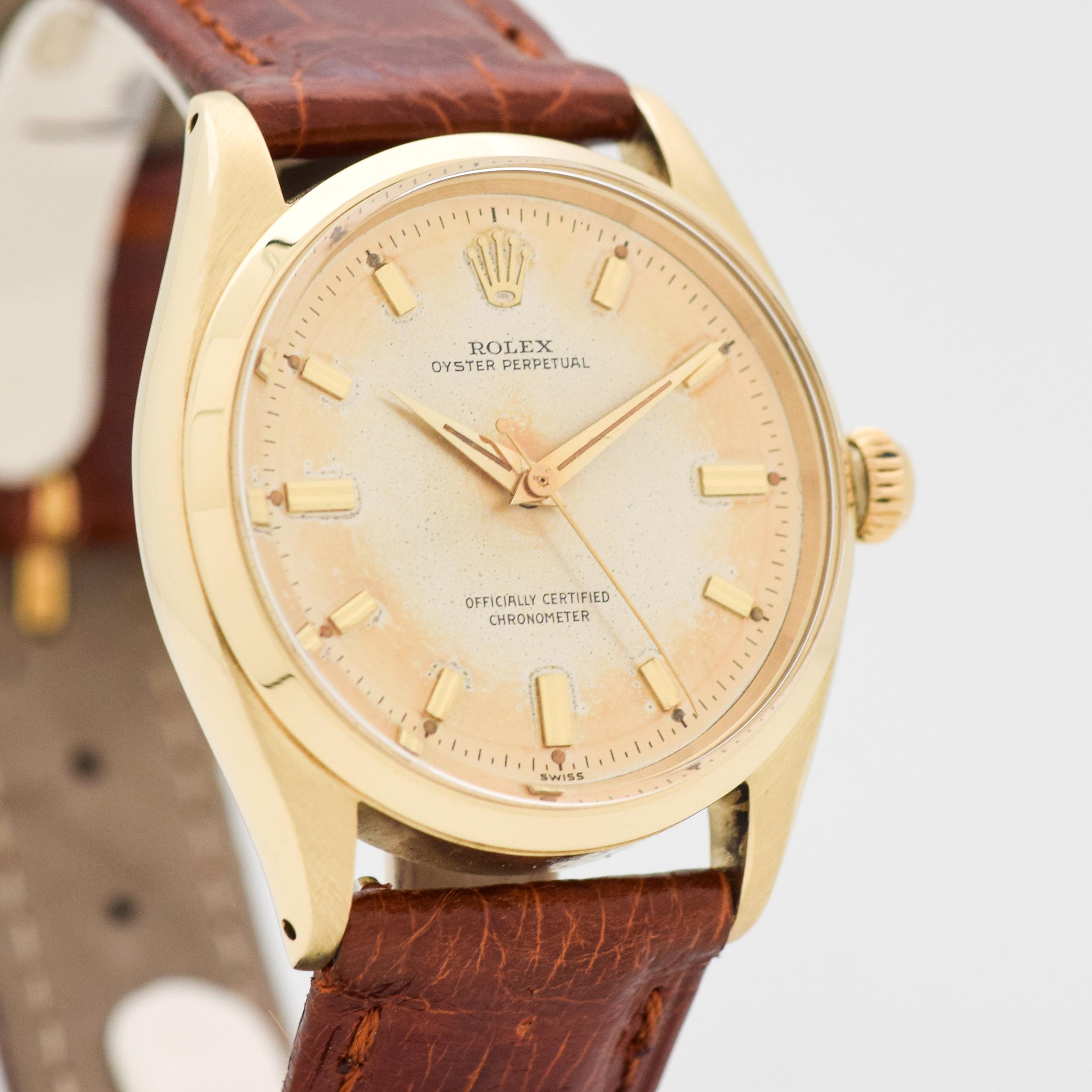 1955 Vintage Rolex Ouster Perpetual Ref. 6564 14k Yellow Gold with Original Silver Dial Turning Golden Brown with Applied Beveled Gold Stick/Bar/Baton Markers. Case size, 34mm x 38mm lug to lug (1.34 in. x 1.5 in.) - Powered by a 25-jewel, automatic