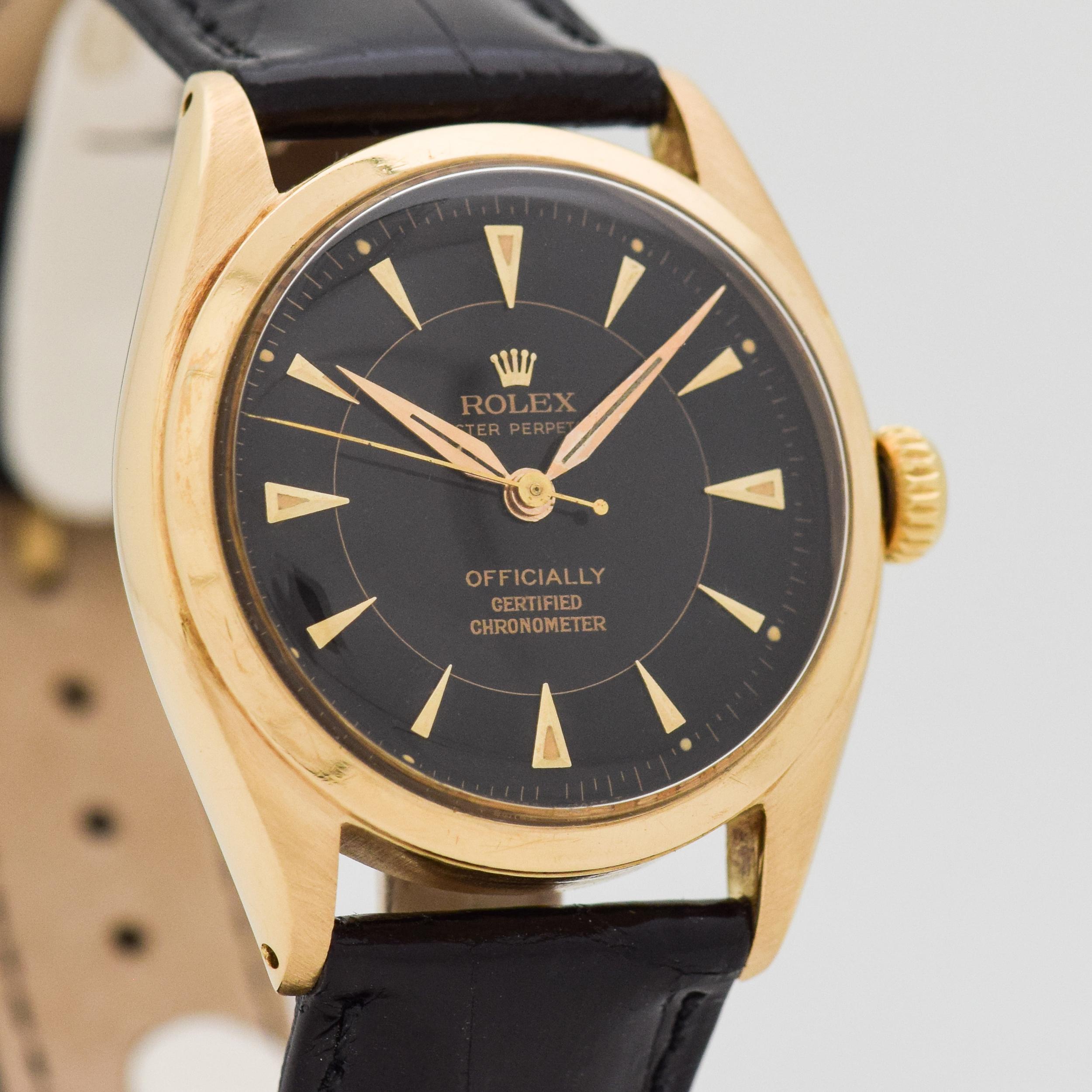 1951 Vintage Rolex Oyster Perpetual Reference 6084. 18K Yellow Gold case. Case size, 34mm wide. Black dial with applied, yellow gold-colored, arrow markers. Powered by a 17-jewel, automatic caliber movement. Equipped with a Glossy, Black-colored,