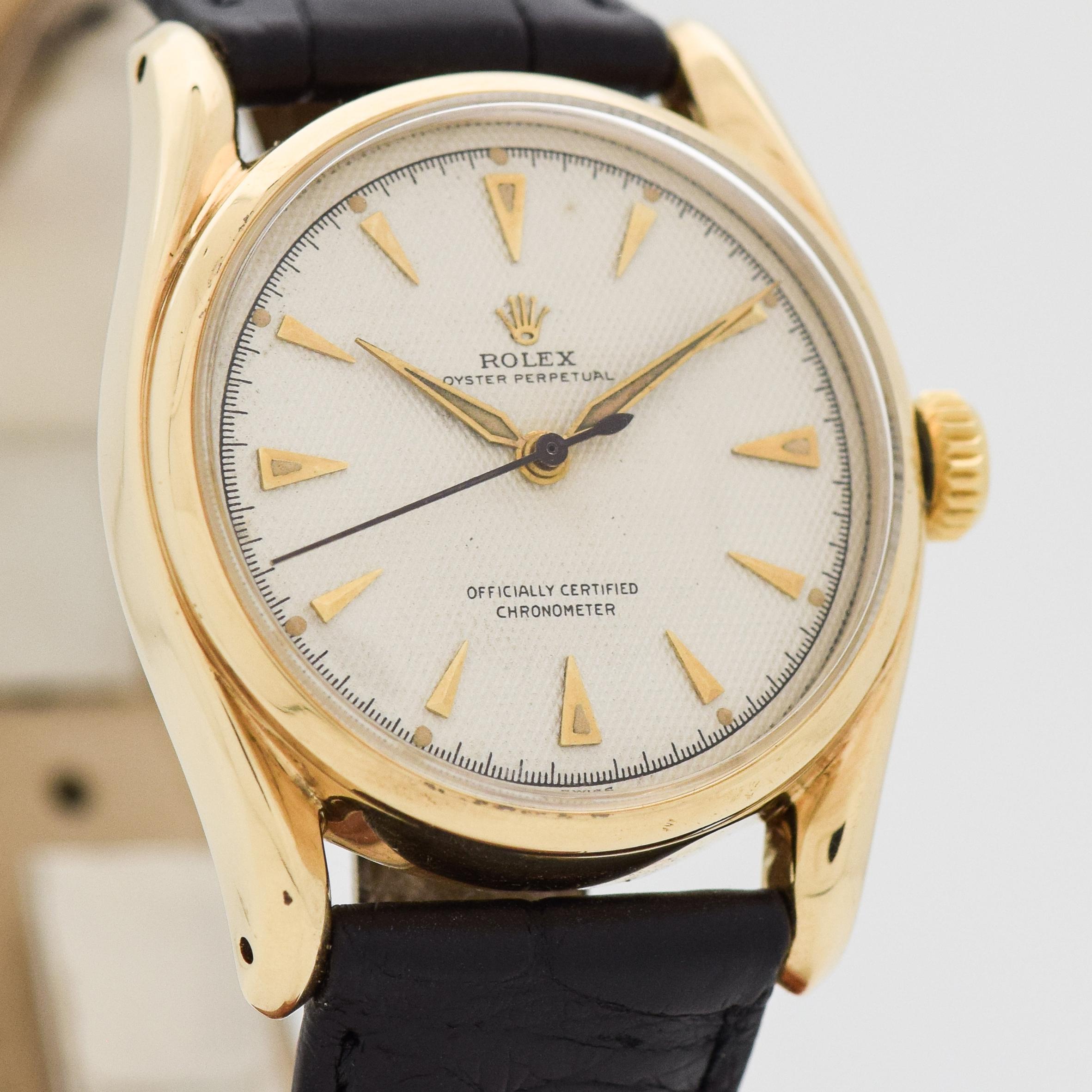 1955 Vintage Rolex Bombe Ref. 6018 14k Yellow Gold watch with Original Waffle Textured Silver Dial with Applied Gold Beveled Elongated Triangle Markers with Rare Copper Gilt Movement. 34mm x 40mm lug to lug (1.34 in. x 1.57 in.) - 17 jewel,