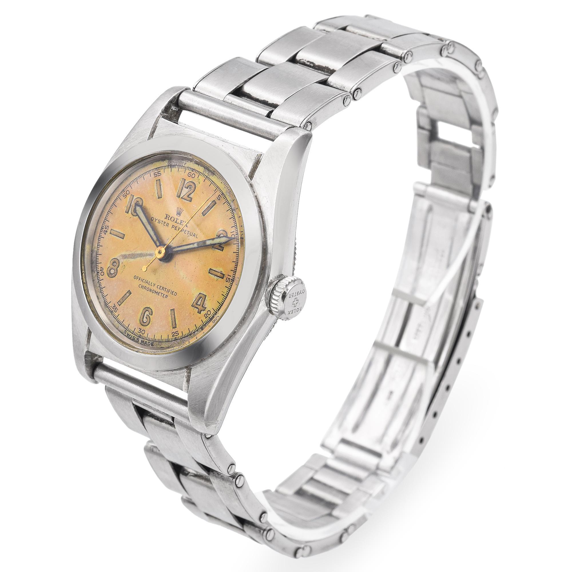 This vintage Rolex Oyster Perpetual is a remarkable example of early Rolex craftsmanship, featuring a manually wound movement housed within the iconic stainless steel Oyster case. The dial has developed a rich, even patina over time, enhancing its