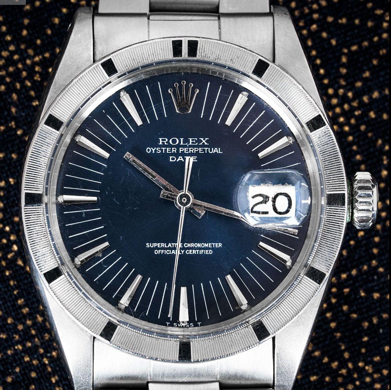A 34mm stainless steel Oyster Perpetual Date by Rolex. Featuring a blue dial with applied hour markers and a steel engine-turned bezel. Fitted with a plastic glass, a self-winding automatic movement and a stainless steel Oyster bracelet equipped