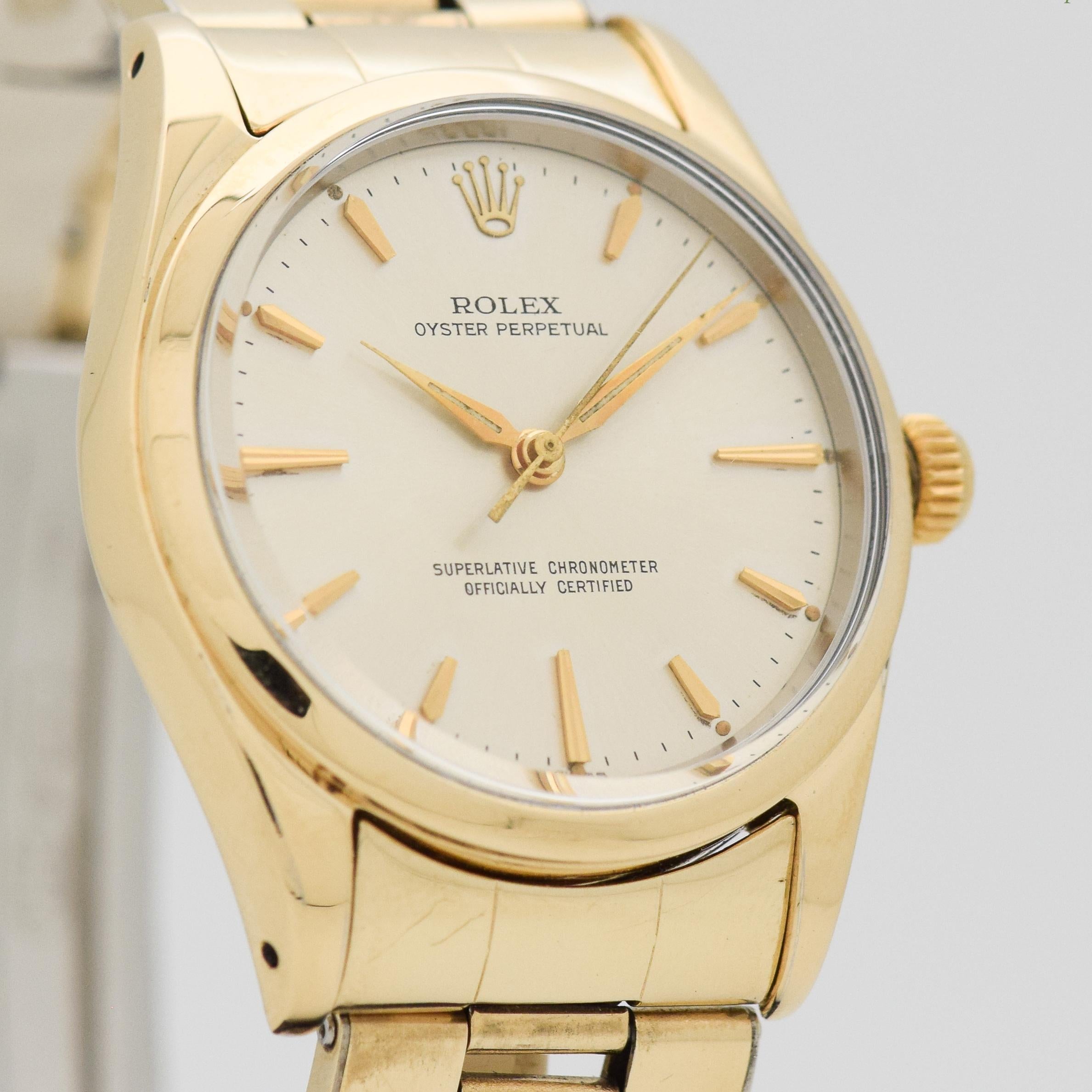 1956 Vintage Rolex Oyster Perpetual Ref. 1014 14k Yellow Gold Shell Over Stainless Steel Case with Original Silver Dial with Applied Elongated Beveled Tipped and Tapering Stick/Bar/Baton Markers with Original Rolex 14k Yellow Gold Plated Stretchy