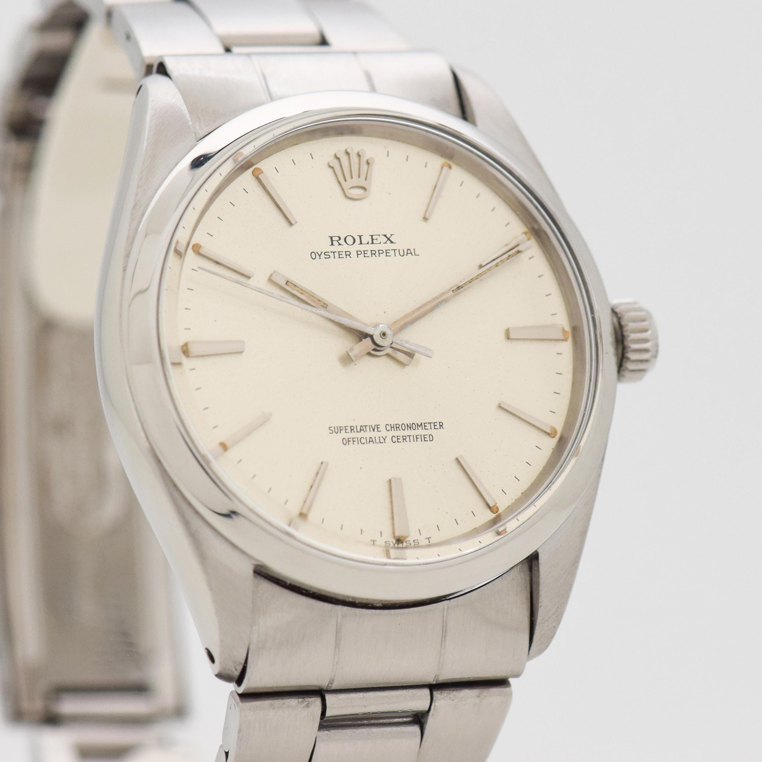 1965 Vintage Rolex Oyster Perpetual Ref. 1002 Stainless Steel watch with Original Silver Dial with Applied Steel Stick/Bar/Baton Markers with Original Rolex Stainless Steel Oyster Bracelet. Case size, 34mm x 38mm lug to lug (1.34 in. x 1.5 in.) -