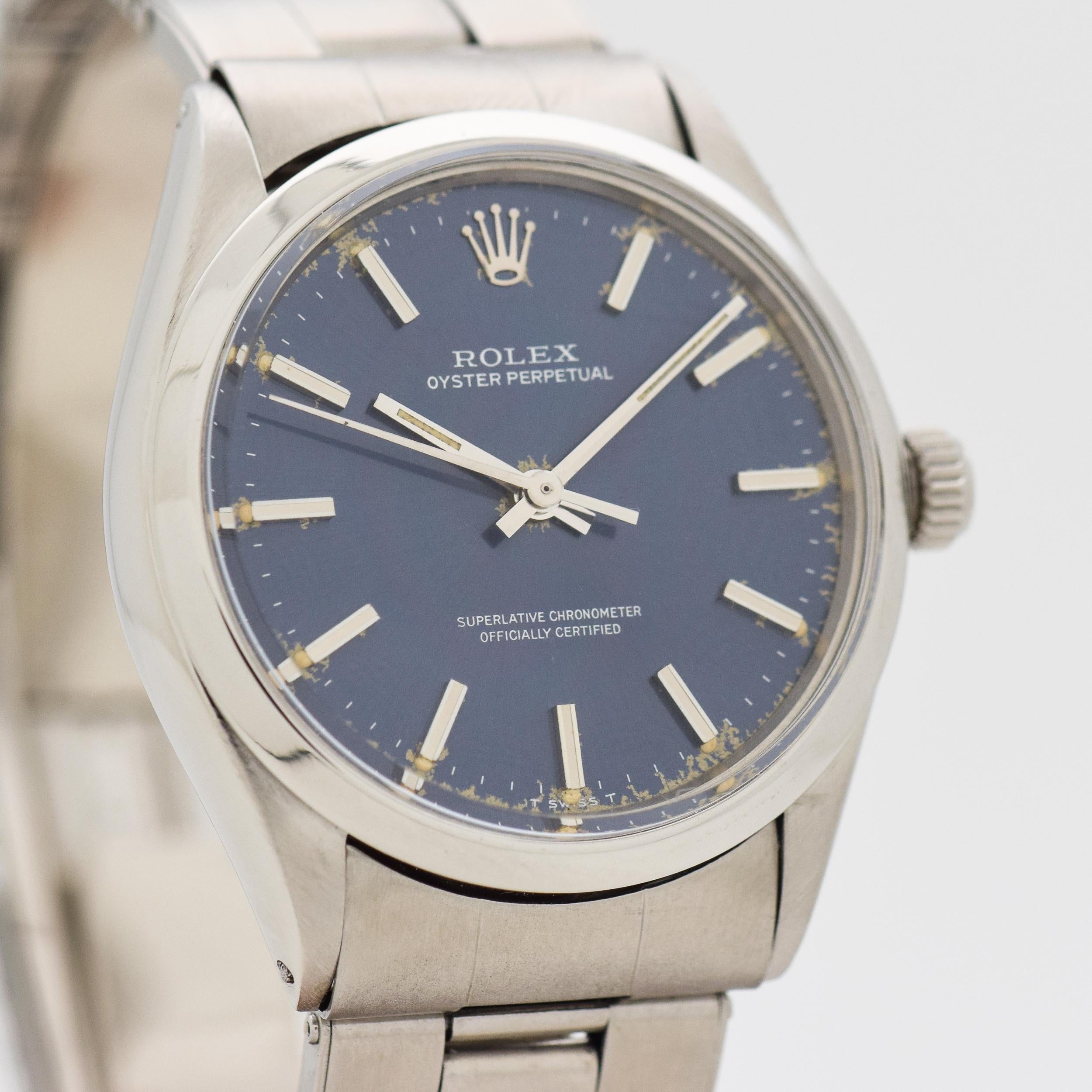 1972 Vintage Rolex Oyster Perpetual Ref. 1002 Stainless Steel watch with Original Blue Dial with Applied Steel Bar/Baton Markers with Black Inlay with Original Rolex Stainless Steel Oyster Bracelet. Fits a 7 1/4 inch Wrist. 34mm x 38mm lug to lug