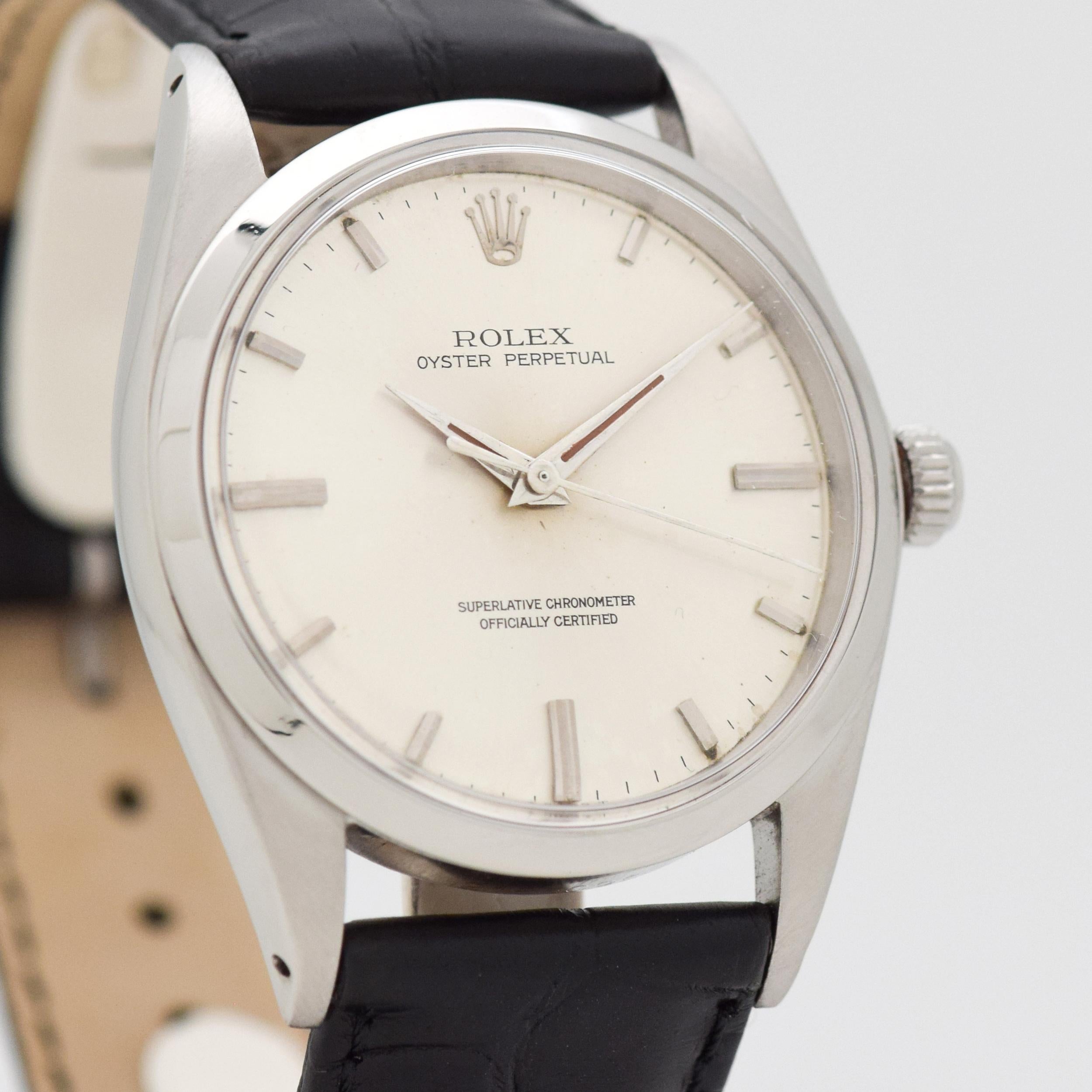 1968 Vintage Rolex Oyster Perpetual Relatively Rare Ref. 1018 36 mm Wide Stainless Steel watch with Original Silver Dial with Applied Steel Stick/Bar/Baton Markers. 36mm x 43mm lug to lug (1.42 in. x 1.69 in.) - Powered by a 26-jewel, automatic
