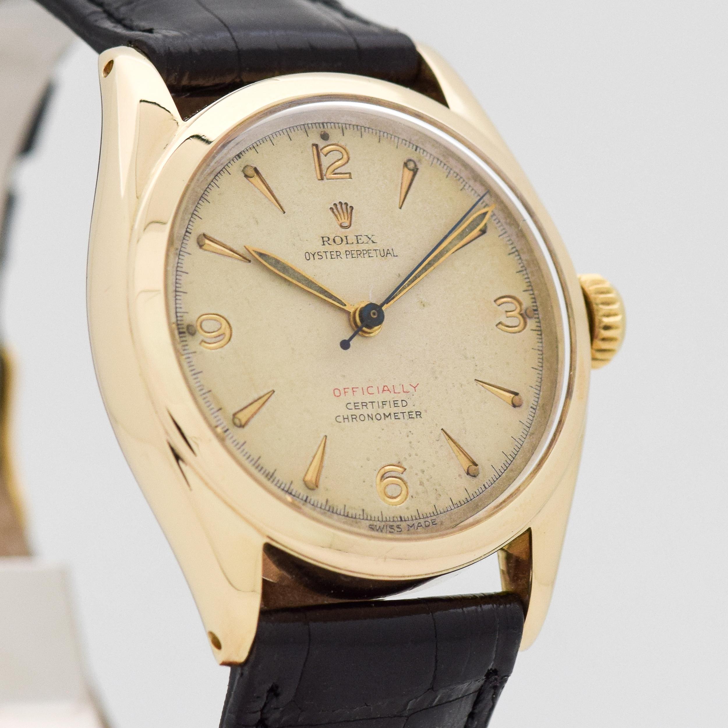 1951 Vintage Rolex Oyster Perpetual Big Semi Bubbleback Ref. 6084 14k Yellow Gold watch with Original Silver Dial with Recessed Gold Color Arabic 3, 6, 9, and 12 with Elongated Beveled Arrow Markers. 34mm x 39mm lug to lug (1.34 in. x 1.54 in.) 20
