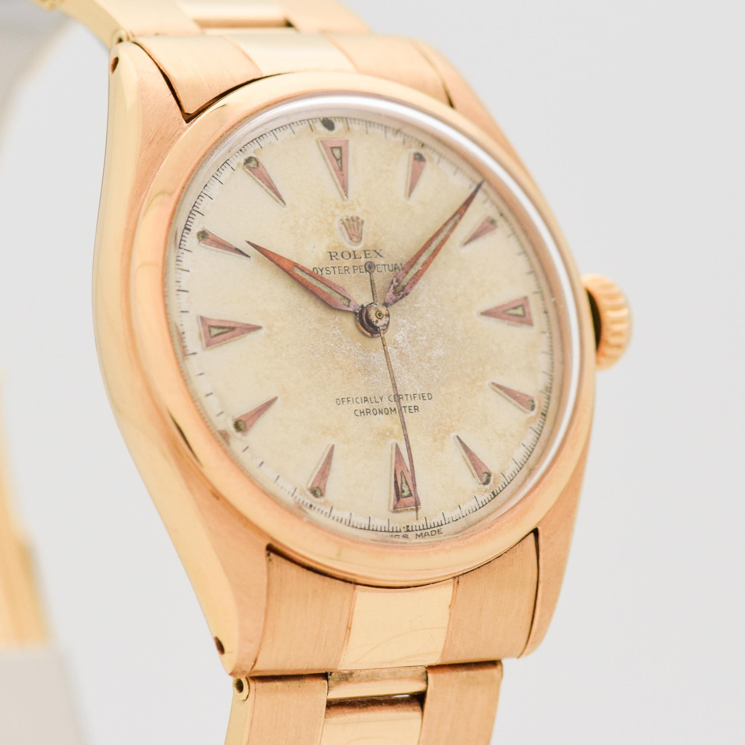 1950 Vintage Rolex Extremely Rare Early Oyster Perpetual 'Super Oyster' Ref. 6084 18k Rose Gold watch with Original Silver Dial with Applied Rose Gold Arrow Markers with Newer Rolex 18k Rose Gold Riveted 'Oyster' Reproduction Vintage Style Bracelet.