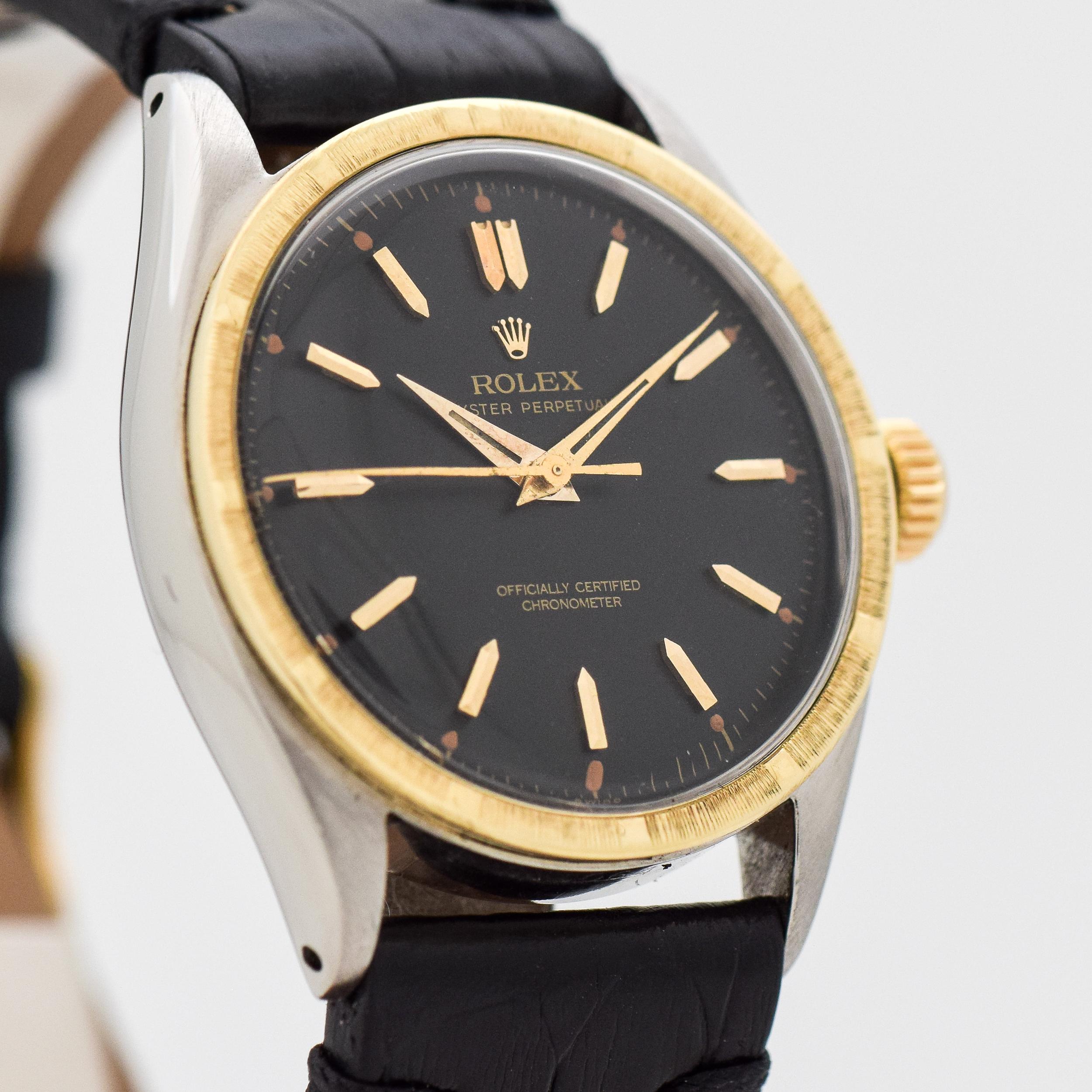 1953 Vintage Rolex Oyster Perpetual Two Tone 14k Yellow Gold Machined Bezel and Stainless Steel watch with Black Dial with Applied Gold Beveled Elongated Pointed Stick/Bar/Baton Markers. 34mm x 38mm lug to lug (1.34 in. x 1.5 in.) - 18 jewel,