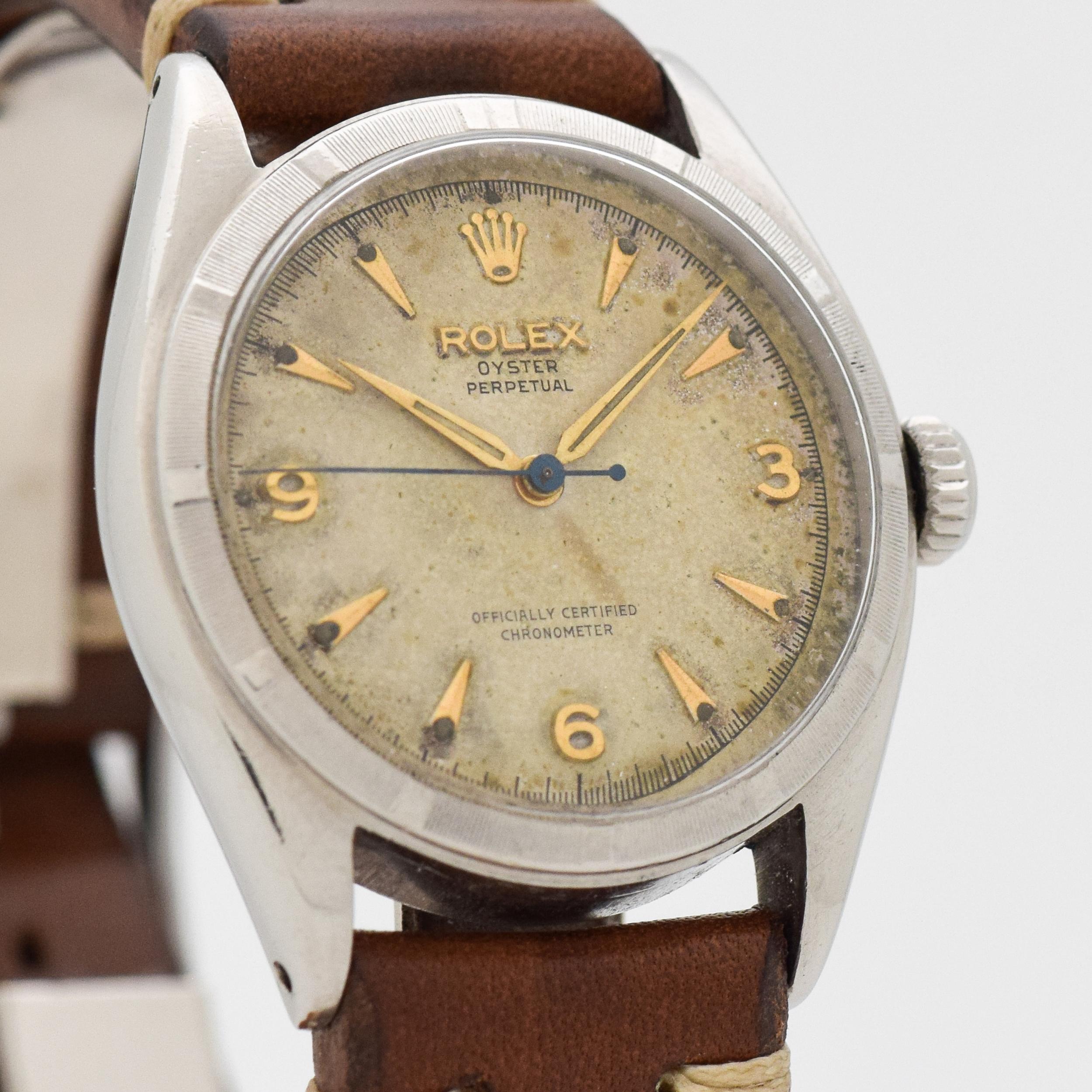 1958 Vintage Rolex Oyster Perpetual Ref. 6085 Stainless Steel watch with Machined Bezel with Original Silver Dial with Applied Gold Color Arabic 3, 6, and 9 with Elongated Beveled Arrow Markers. 34mm x 38mm lug to lug (1.34 in. x 1.5 in.) - 17