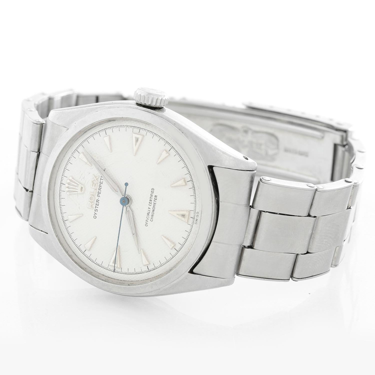 Vintage Rolex Oyster Perpetual Stainless Steel Men's Watch Ref. 6084 - Automatic winding. Stainless steel case with smooth bezel ( 34 mm ). White guilloche dial  with luminous hour markers. Stainless Steel Oyster bracelet; will fit up to a 7 1/4