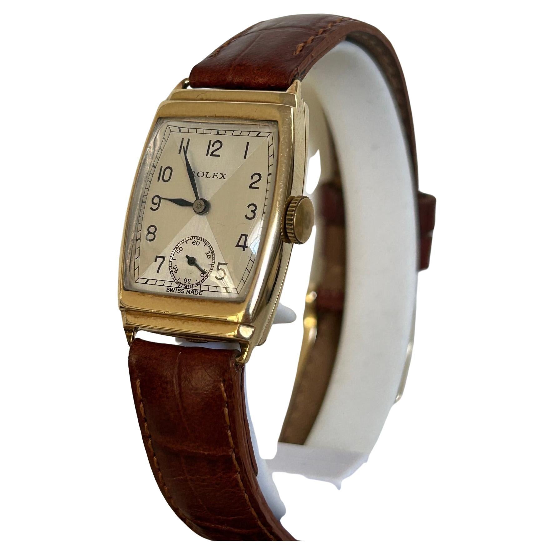 Our wonderful vintage Rolex features a 9k yellow gold stepped tonneau shaped case with manual wind 15 jewel movement. Notably, this example has a very attractive art deco style dial with sub seconds and blued hands, and is presented in oustanding