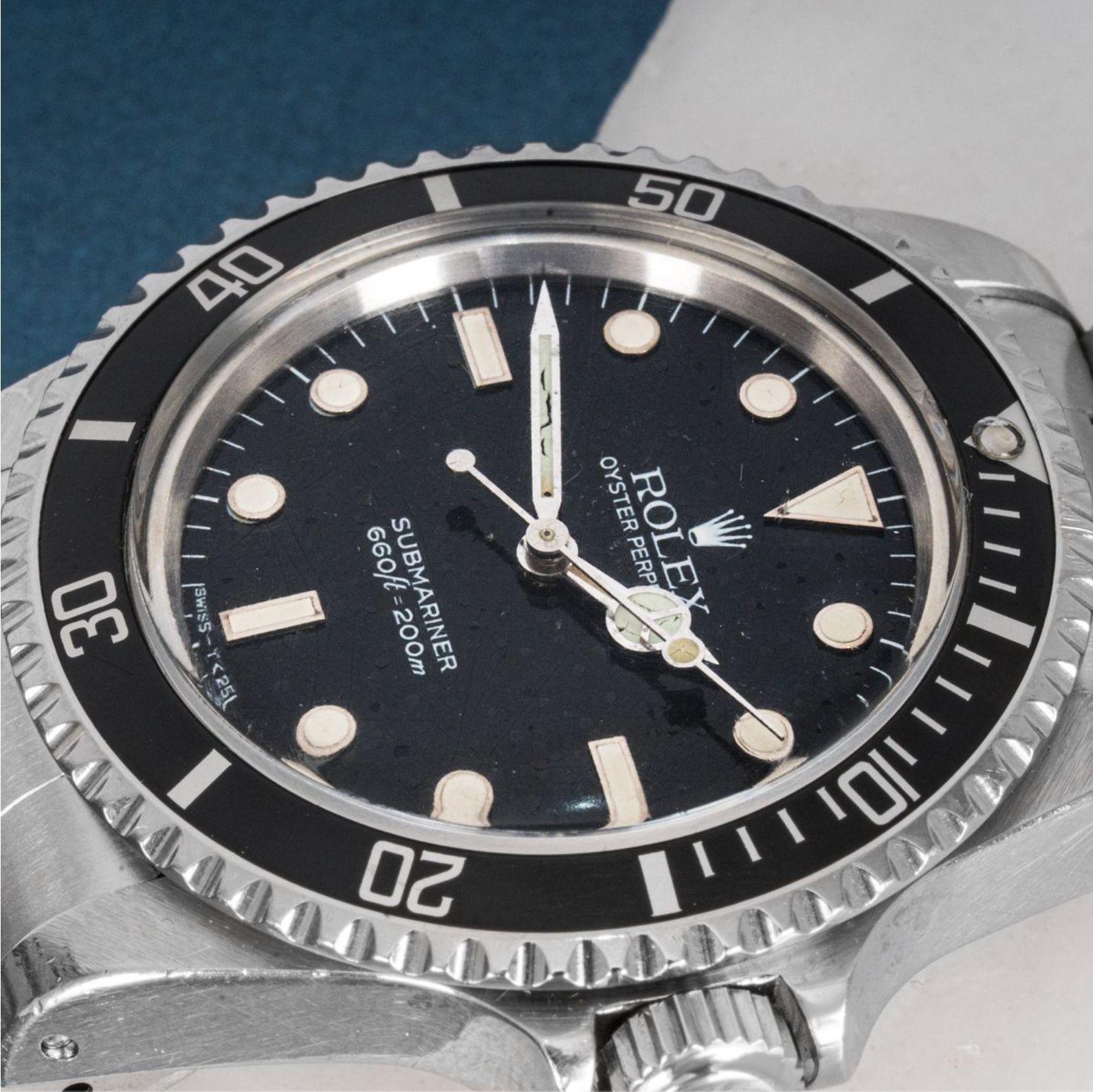 A stainless steel Submariner by Rolex. Featuring a distinctive black glossy spider dial with applied hour markers and a uni-directional rotatable bezel.

Fitted with a plastic glass, a self-winding automatic movement and an Oyster bracelet equipped