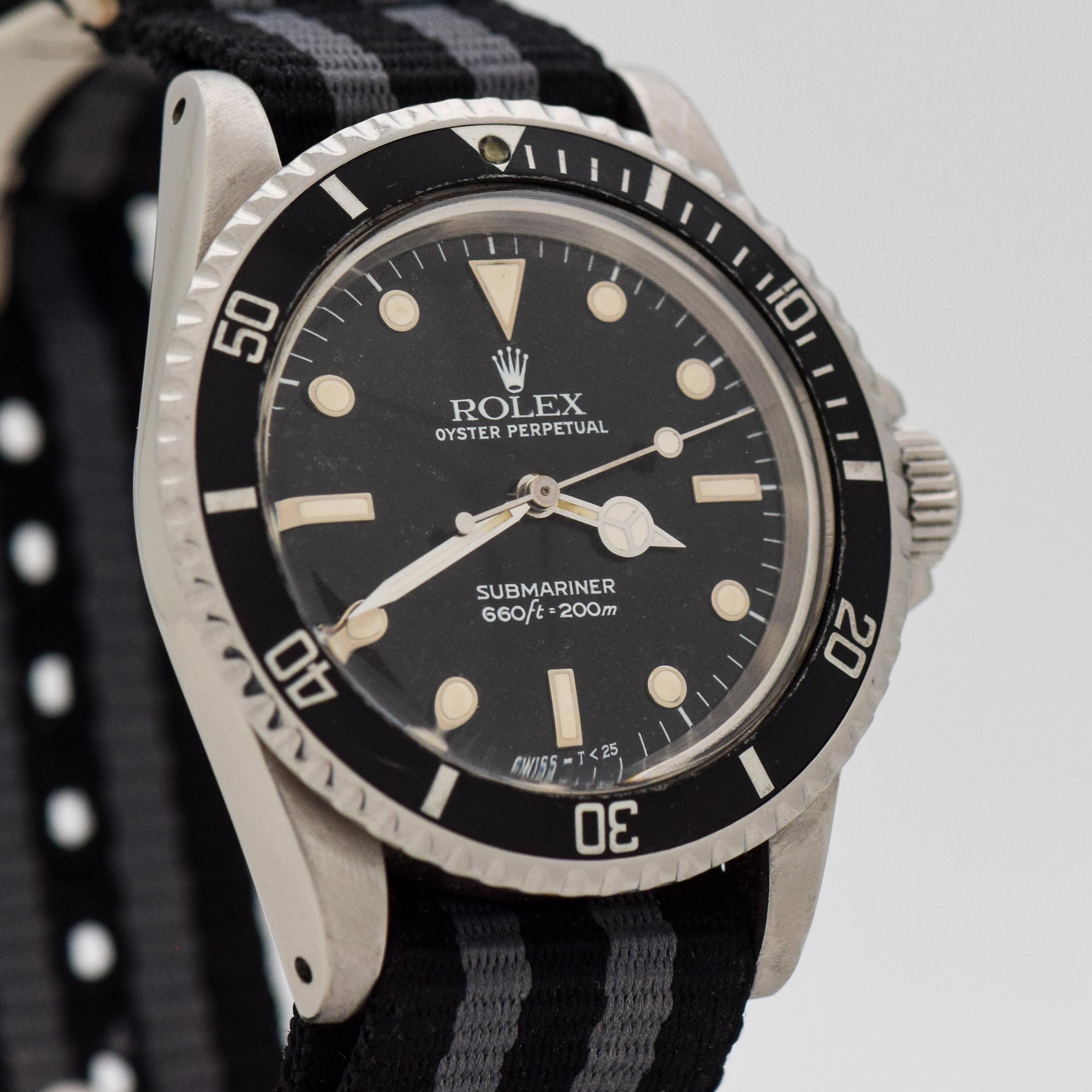 1986 Vintage Rolex Submariner Reference 5513. Stainless Steel case, that measures in at 40mm wide. Original, patinated black dial. Original bezel insert. Powered by a 26-jewel, automatic caliber 1520 movement. Equipped with a two-tone, Black &