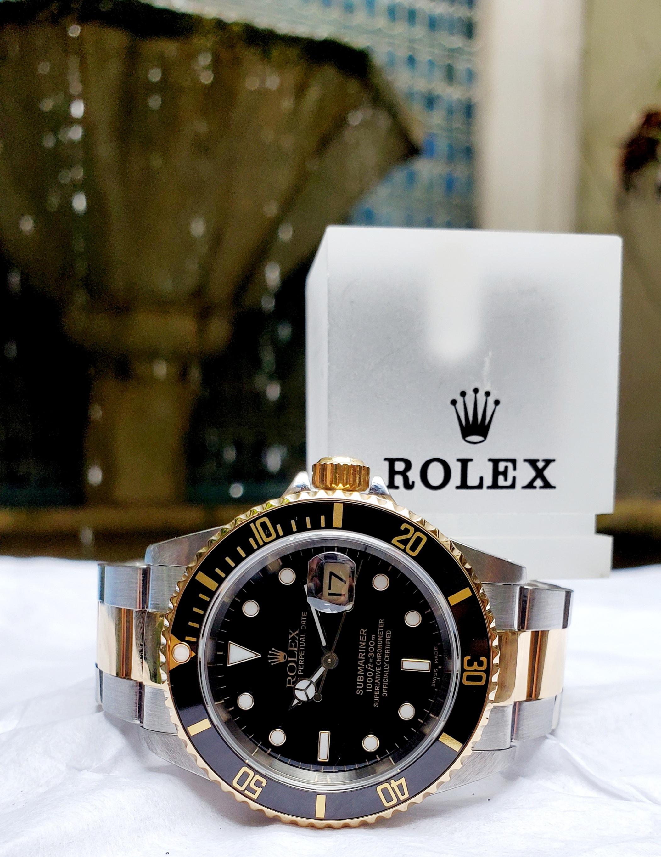 This is an extremely fine example of a well cared for vintage Rolex. This Submariner with Black Dial and Bezel is constructed from  Stainless Steel and 18kt yellow gold. The Oyster link style bracelet holds its form and is situated with a good