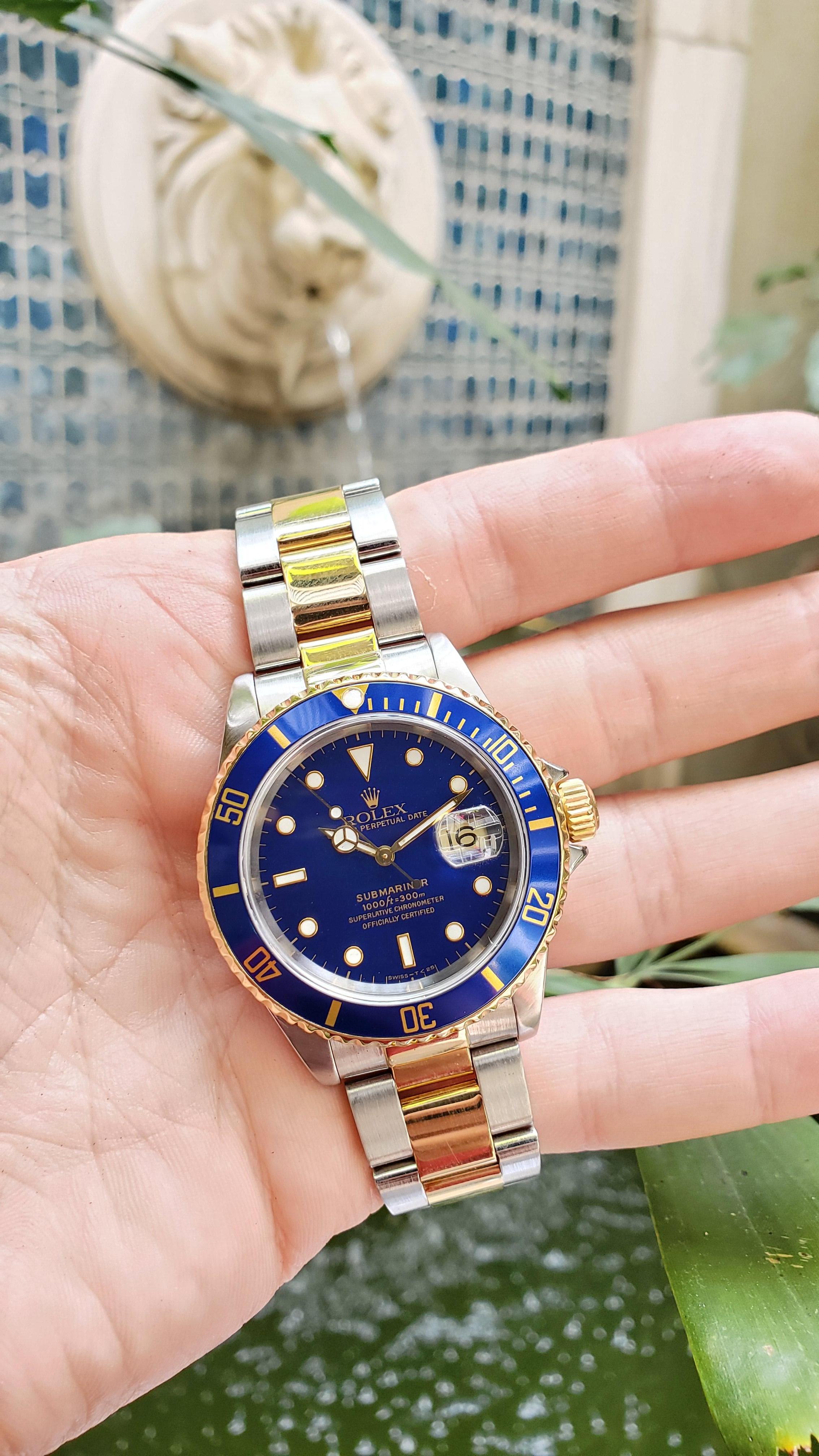 Vintage Rolex Submariner, circa 1997. Stainless steel and 18kt yellow gold Submariner with blue dial and blue bezel. 

Classic Rolex Sub with vintage blue color. Bracelet is tight and clean condition. All of our watches go to an Authorized Rolex