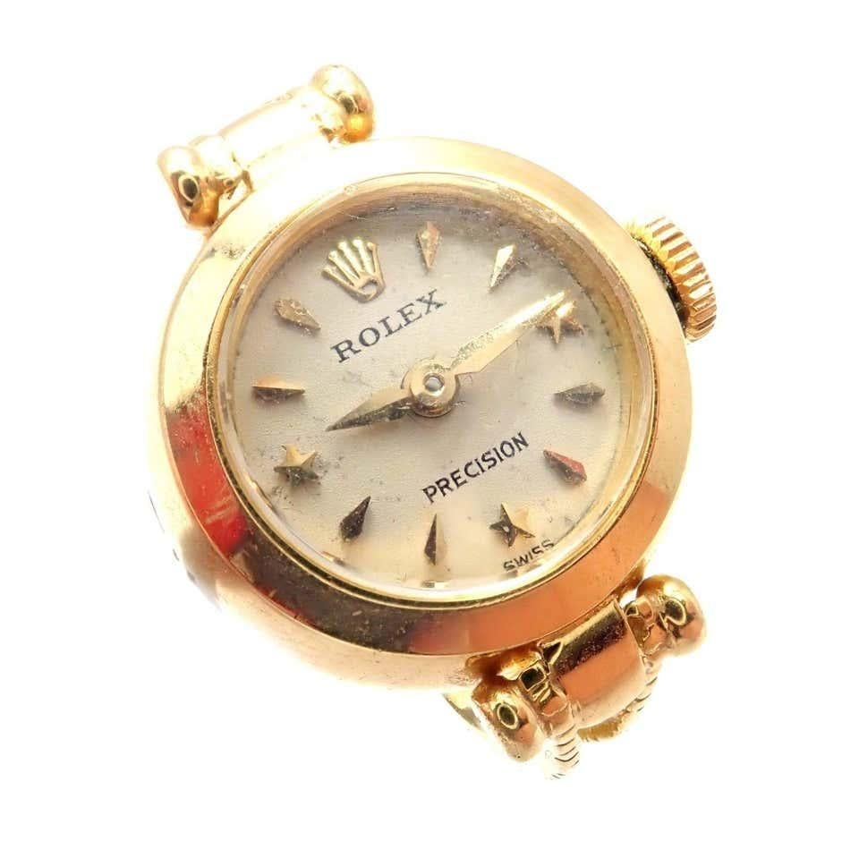 18k Yellow Gold Vintage Ring Watch by Rolex. 
Details: 
Ring Size: 4
Weight: 8.5 grams
Case Top: 15mm x 19.5mm
Movement: Manual cal. 280 17J Movement
Stamped Hallmarks: Dial: Rolex Precision
Case Back: Rolex Logo, 463137
Crown: Rolex Logo
Also: