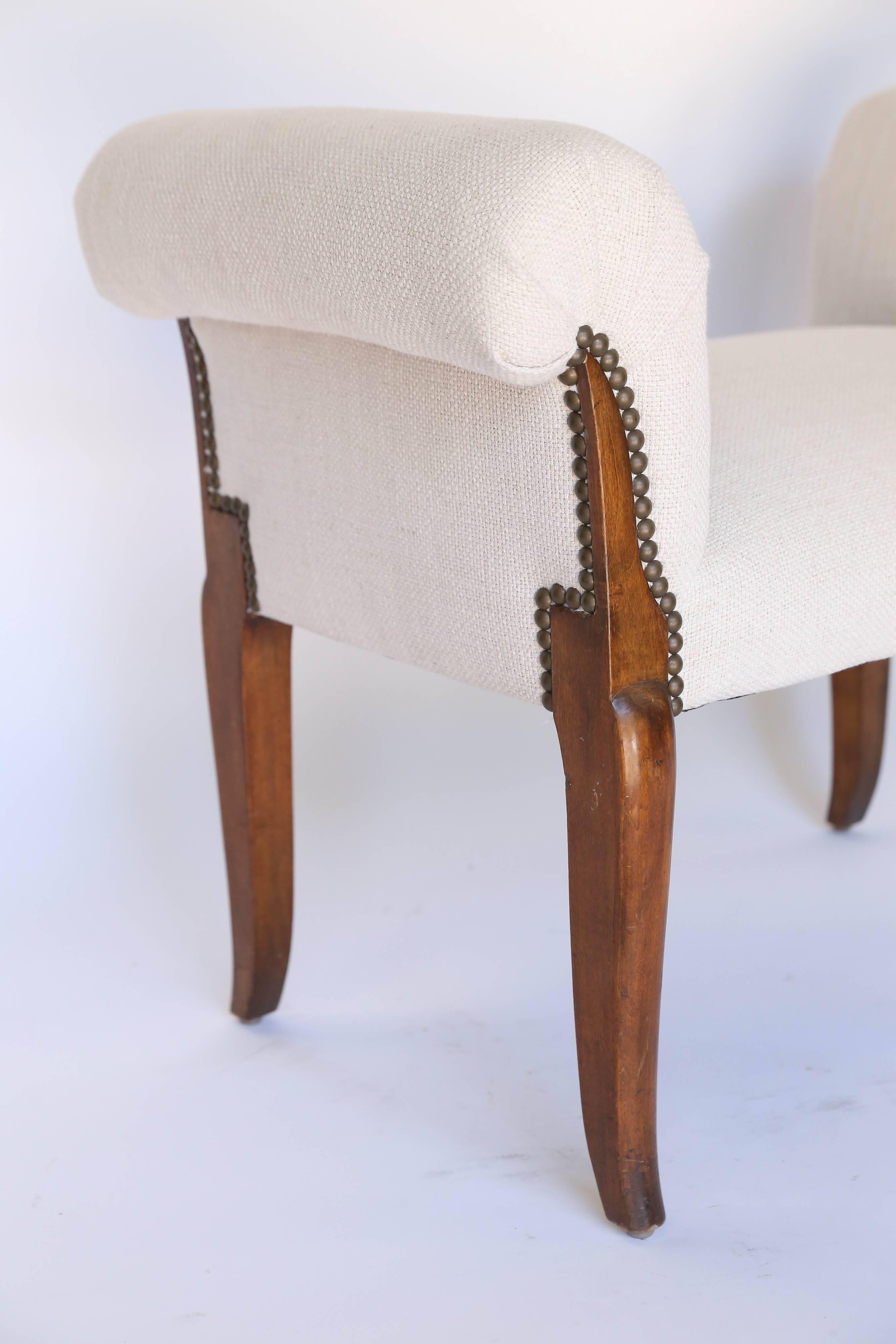 Vintage roll arm upholstered window seat bench with beautiful wood splayed legs and metal nailhead detail trimming the legs.