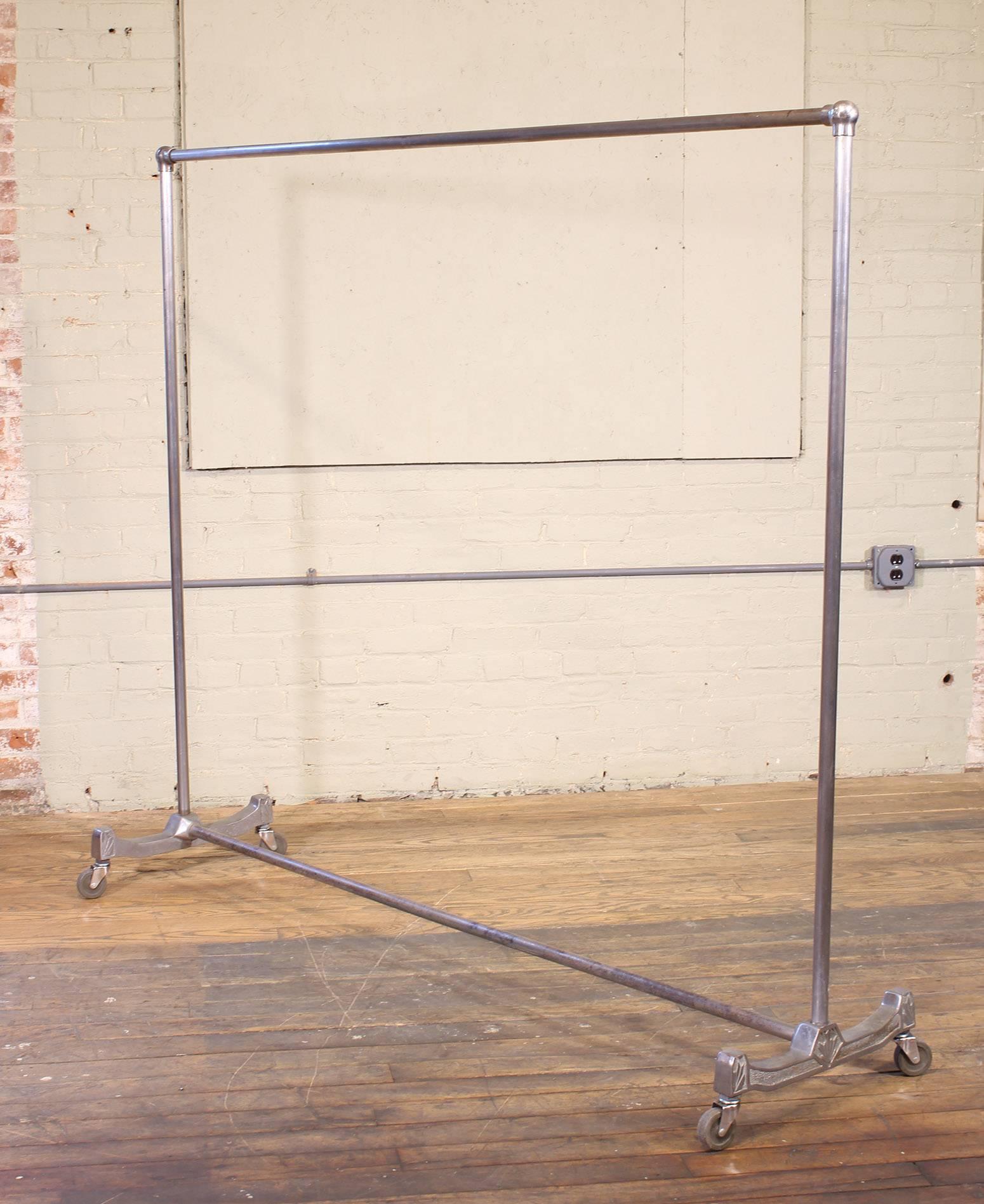 Vintage Art Deco garment rolling coat, clothing rack, stand. Made from cast aluminium, iron and steel. Measures: 62 3/4