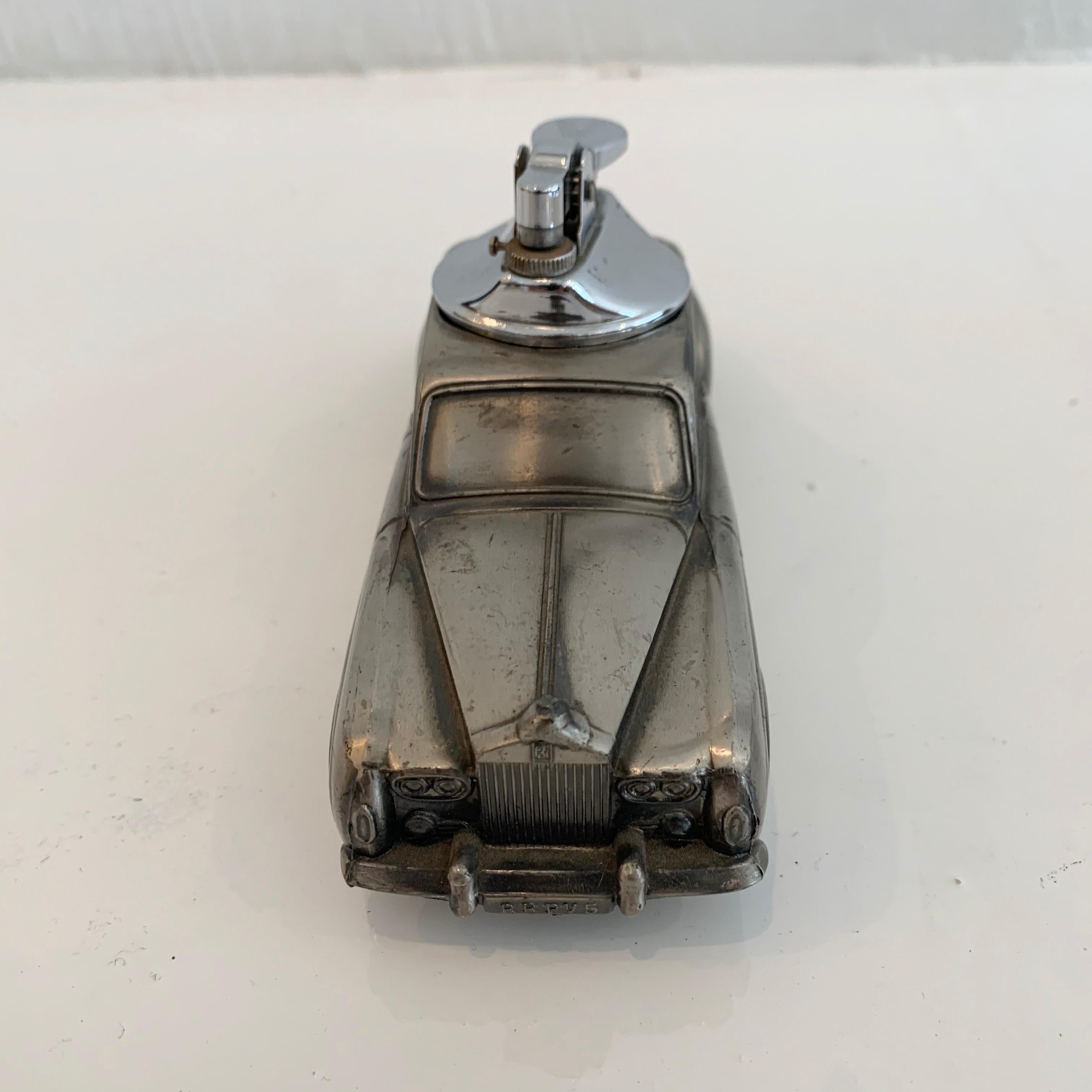 Cool vintage table lighter in the shape of a phantom, Rolls Royce. Great vintage condition. Cool tabletop object.
  