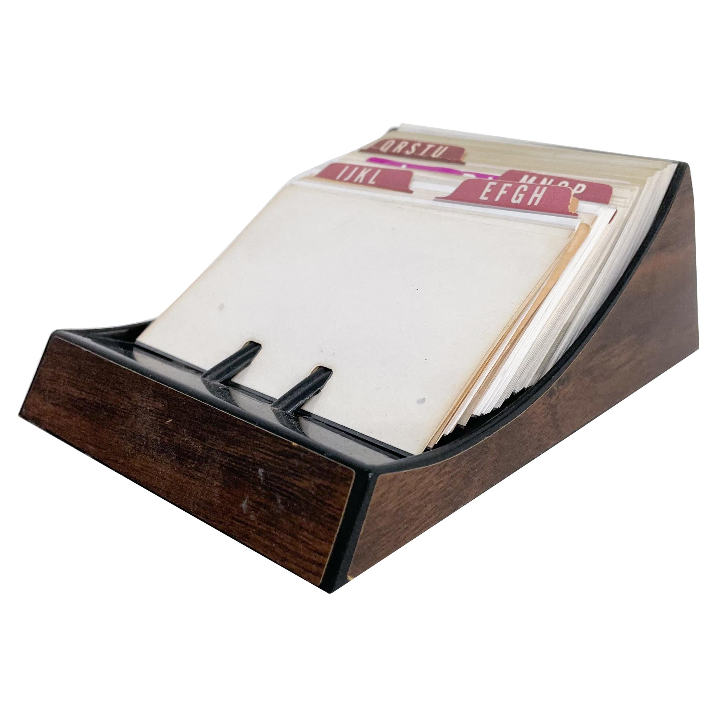 Rolodex
Vintage Rolodex Card File Tray in Faux Wood Midcentury Modern Madmen Classic
6.25 x 4.5 x 2.25 tall
Beautifully aged paper file cards.
Original Unrestored Preowned Fair Vintage Condition. 
Selling as presents in images.
Fast shipping.
 