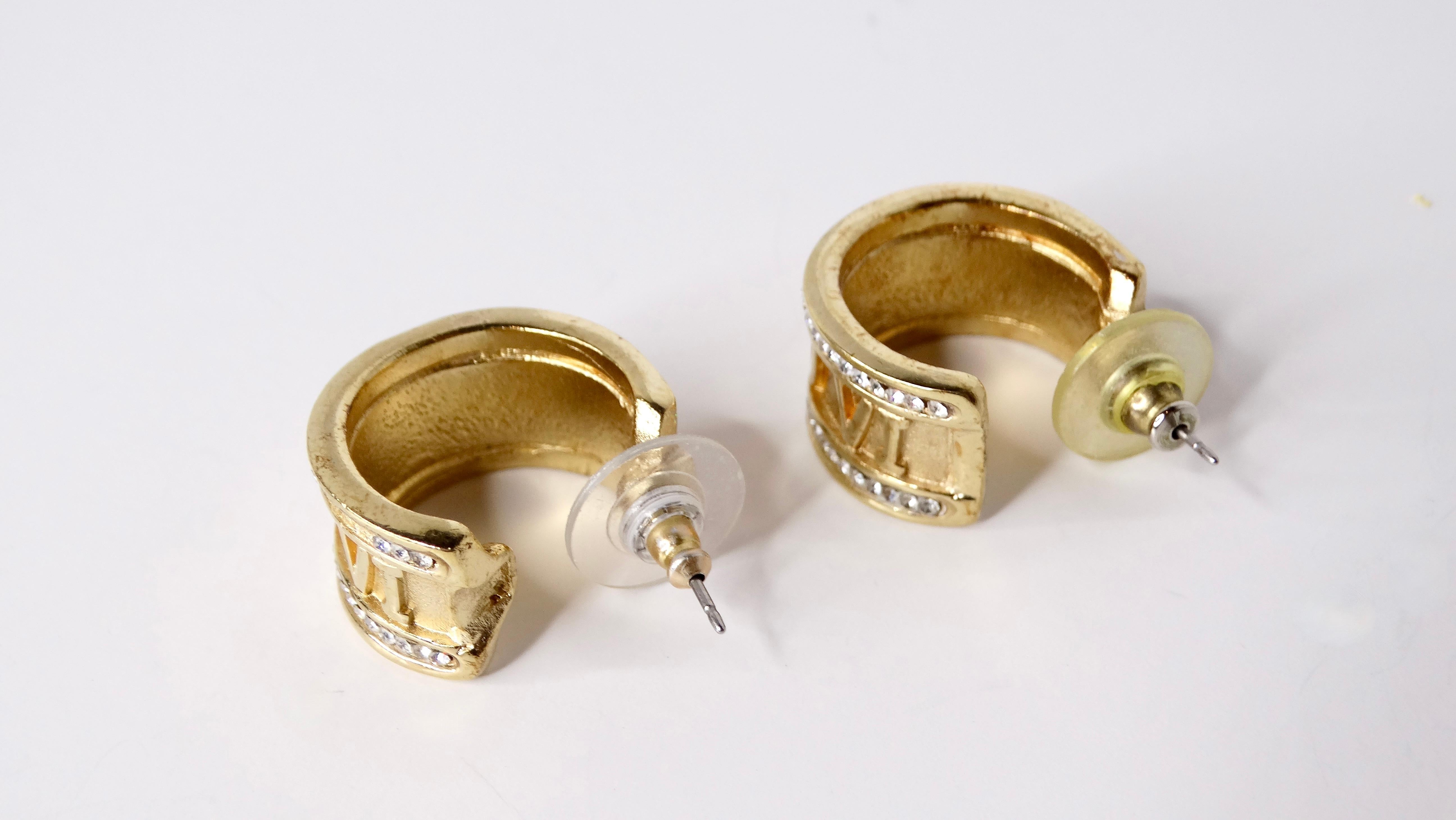 Elevate your accessory game with these Vintage Roman Numeral Rhinestone & 14k Gold Plated Hoop Earrings. Crafted with an exquisite balance of small yet thick design, these hoops showcase a dazzling array of rhinestones that accentuate the shimmering