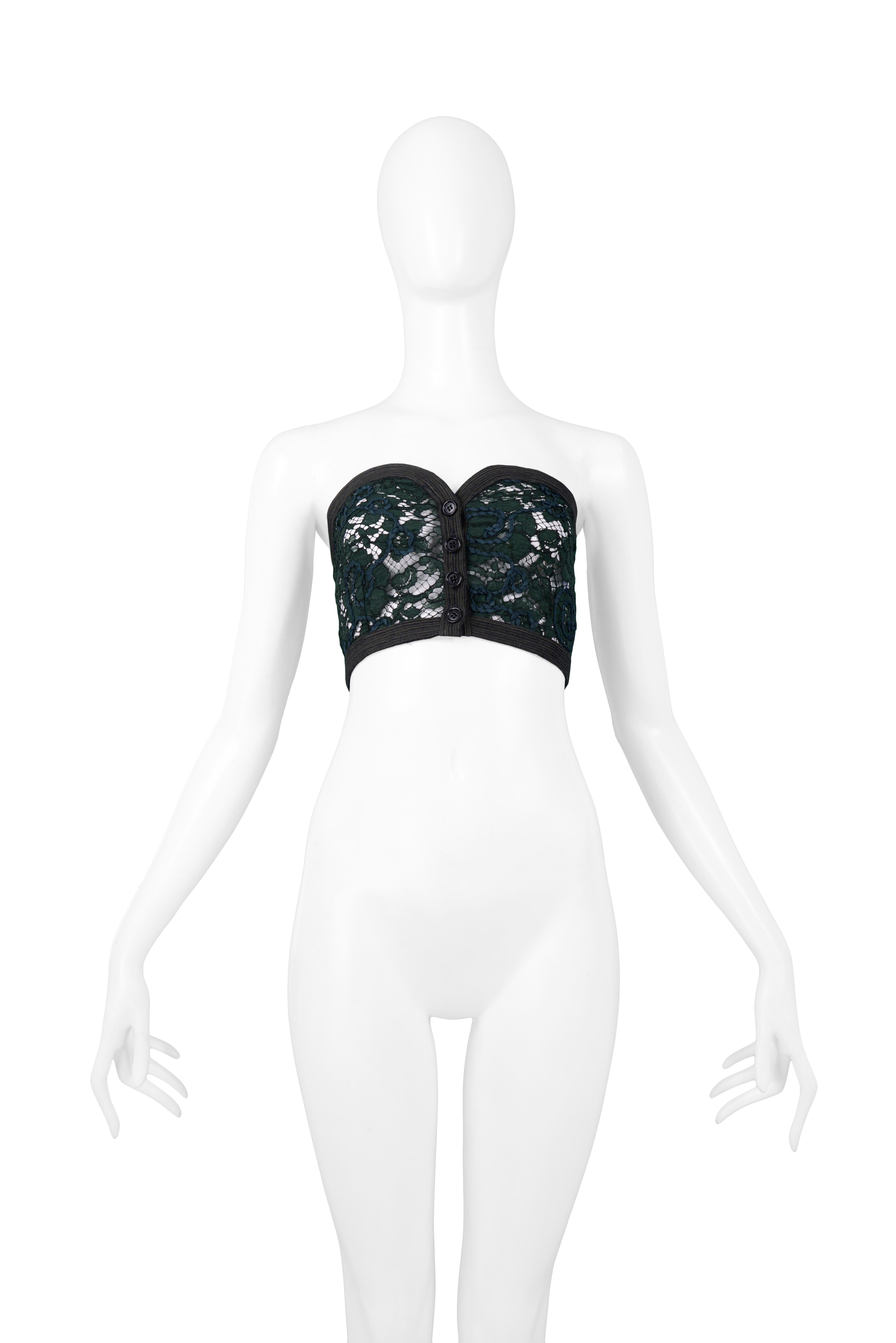 Resurrection Vintage is excited to offer a vintage Romeo Gigli dark green cotton lace crop top featuring a bustier fit, ribbon trim, and 4 button front closure. From the 1990 Collection.

Romeo Gigli, Italy
Size 42
Lace
1990 Collection 
Excellent