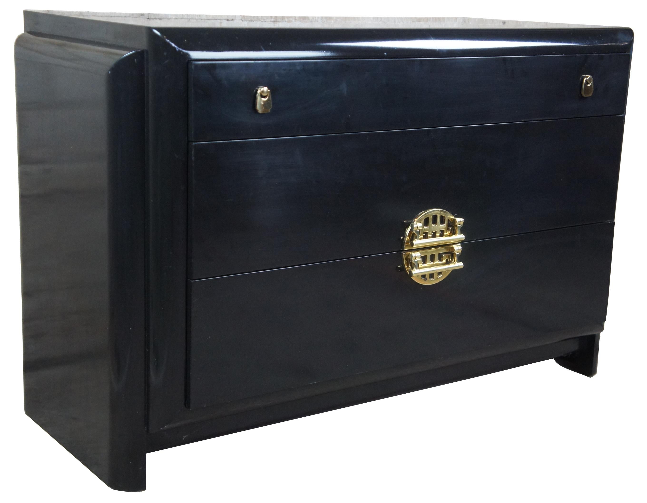 Mid-20th century modern dresser by Romweber Furniture. Features an Asian inspired design with black lacquer finish and nickel polished hardware with oriental motif. Measures: 44