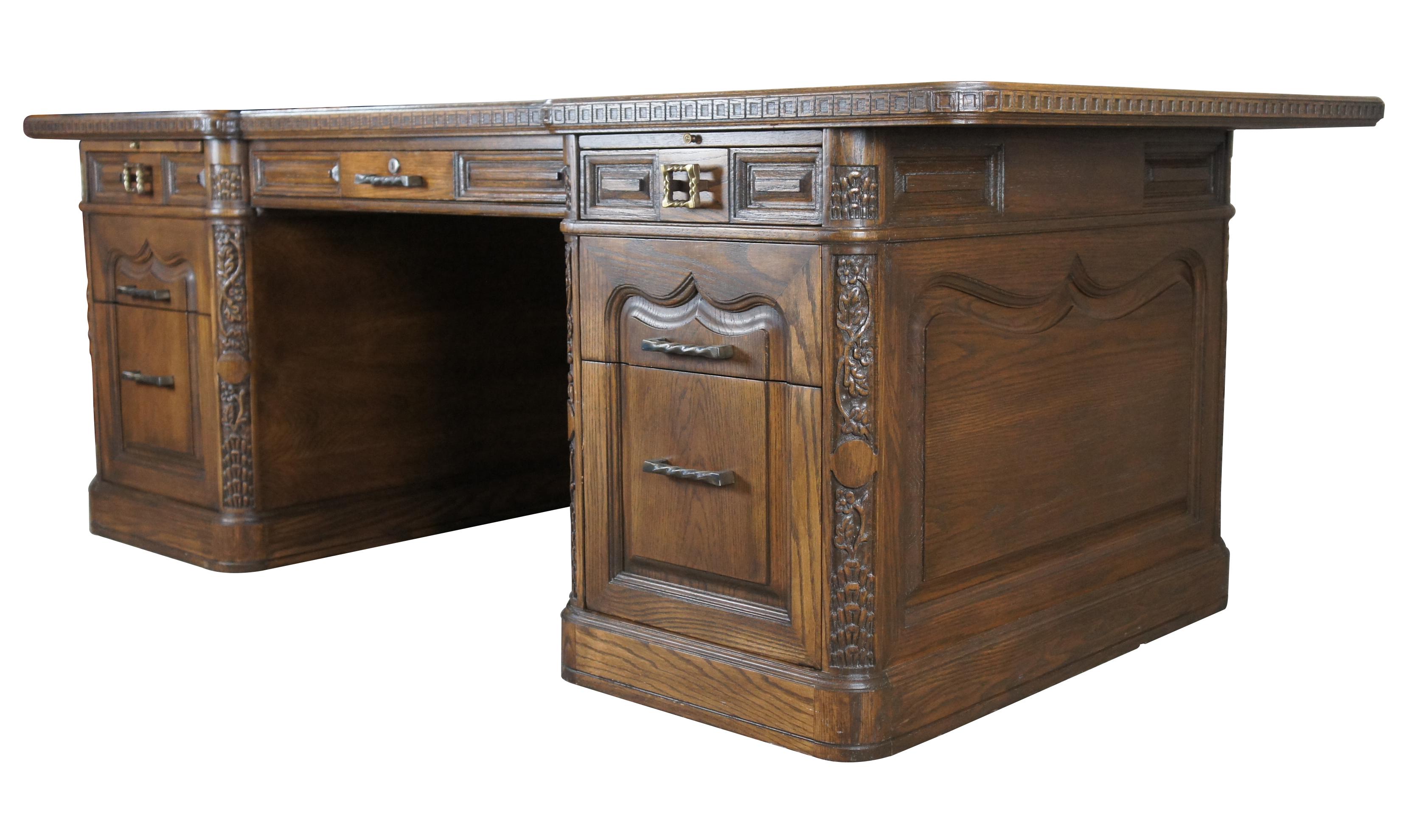 Romweber (R-10975) Viking oak executive desk circa 1980s. Features a large oak top with bowtie (butterfly joint) dovetailing and square carved edge. The top overhangs along the sides and front. The base of the desk has shapely Nordic inspired