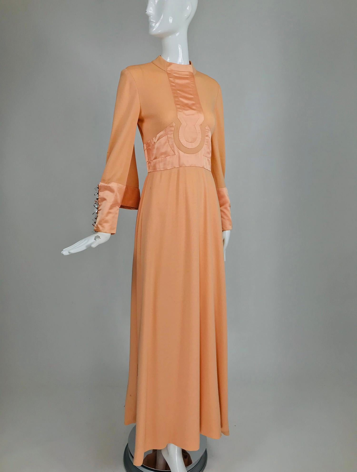 Ronald Amey peach wool knit gown with pieced satin bodice front and neck yoke from the 1960s. This beautiful dress has a Mod influenced design. The dress is beautifully constructed. In the day wool was regularly used for day and evening garments