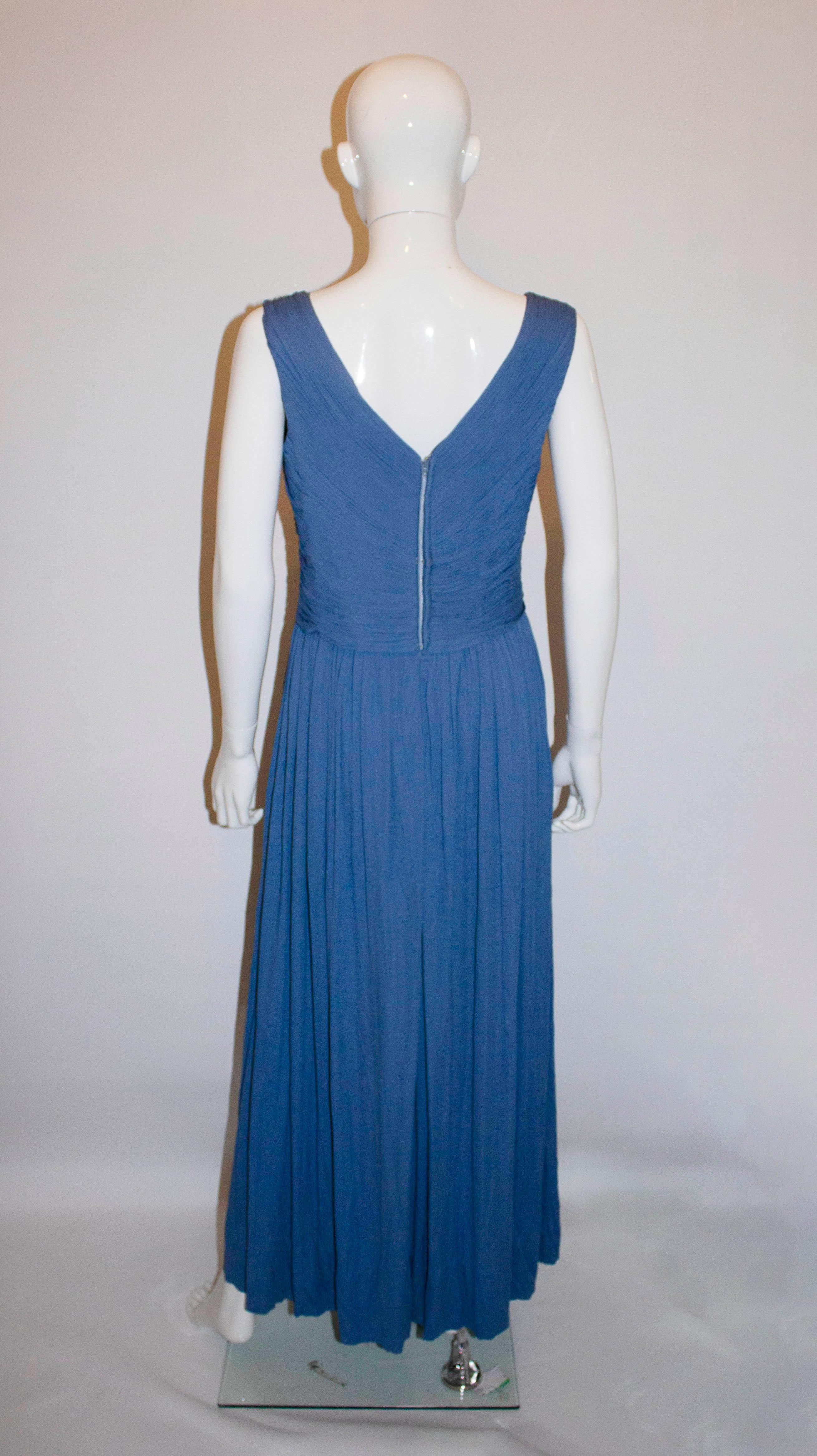 A wonderful jersey drape vintage jersey gown by Ronerg Couture. The dress has a v neckline and backline with plait detail over the bodice,ad gathering at the skirt. 

Measurements: Bust 37'', length 56'' plus a 4 1/2'' hem.