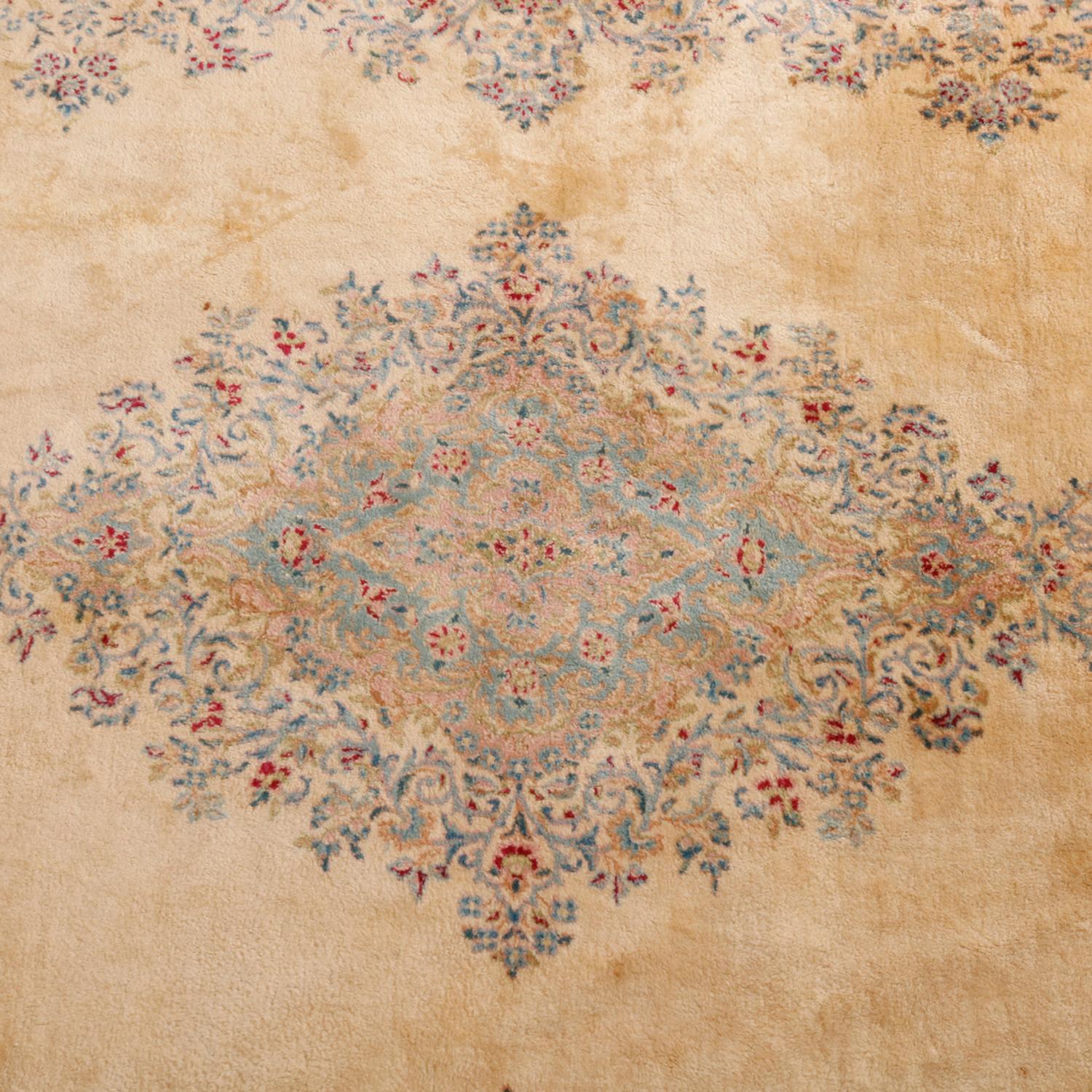 A vintage room size Kerman Persian oriental rug offers central medallion and border with pastel floral elements on cream ground, circa 1950

***DELIVERY NOTICE – Due to COVID-19 we are employing NO-CONTACT PRACTICES in the transfer of purchased
