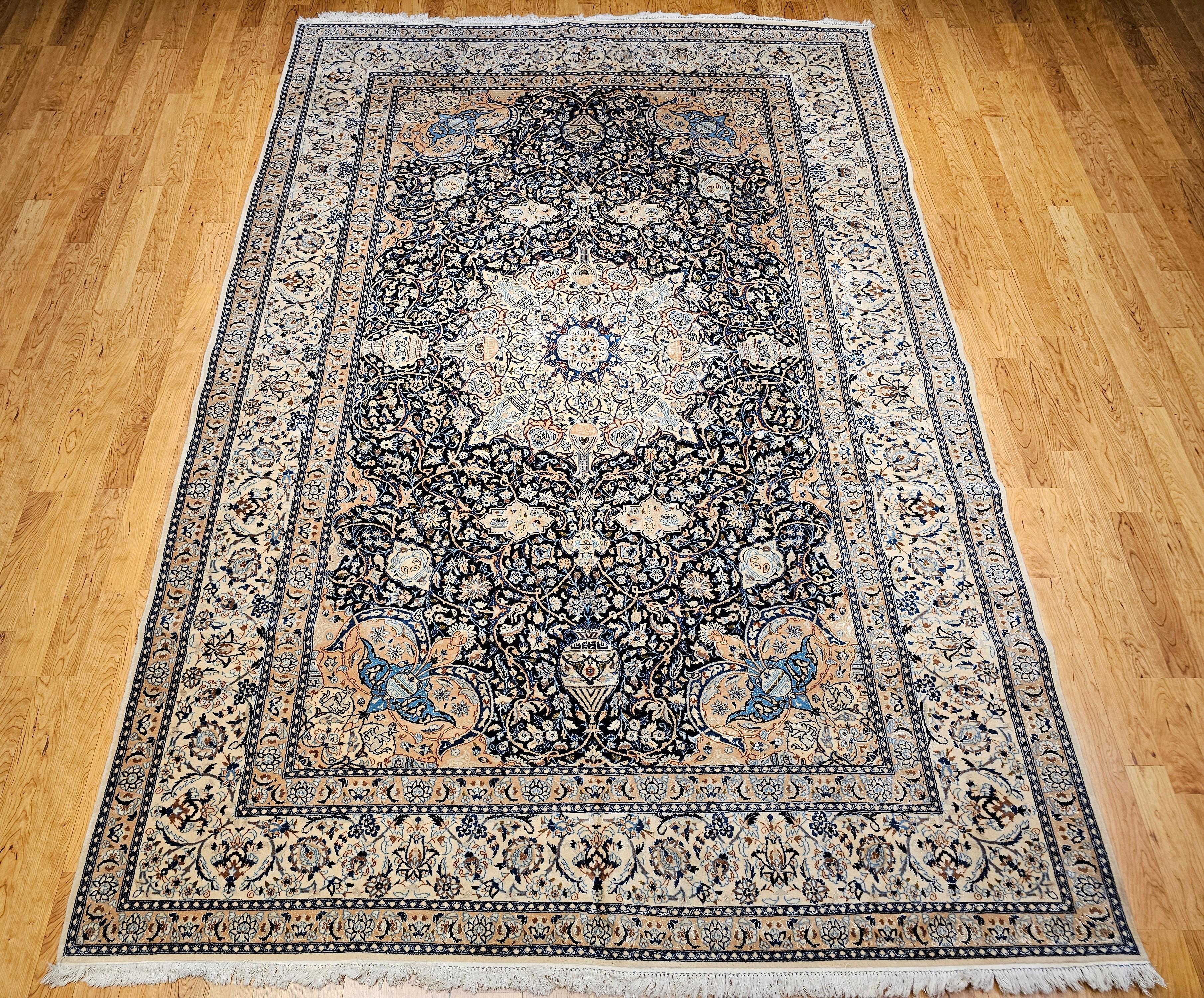 This finely woven Persian Nain rug, dating from the 3rd quarter of the 1900s, is a striking example of the elegance and precision found in Nain workshop weavings. Designed with a refined floral motif and a beautifully detailed central medallion,