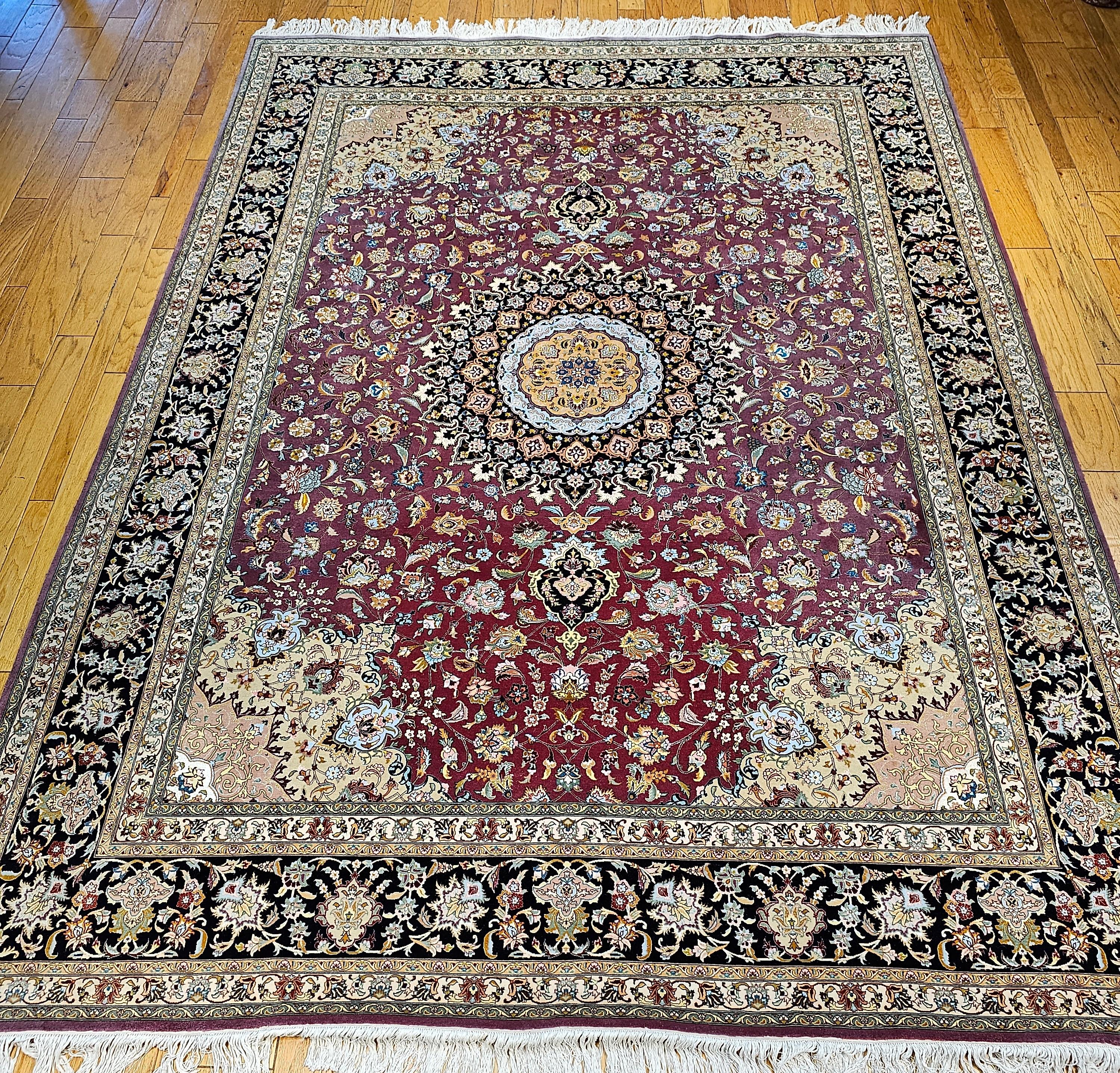 A very fine weave hand-knotted Persian Tabriz room-size rug was very finely woven in one of the best workshops in the City of Tabriz in the 4th quarter of the 1900s.   This Tabriz rug has a beautiful floral design set in a rich burgundy or pale plum